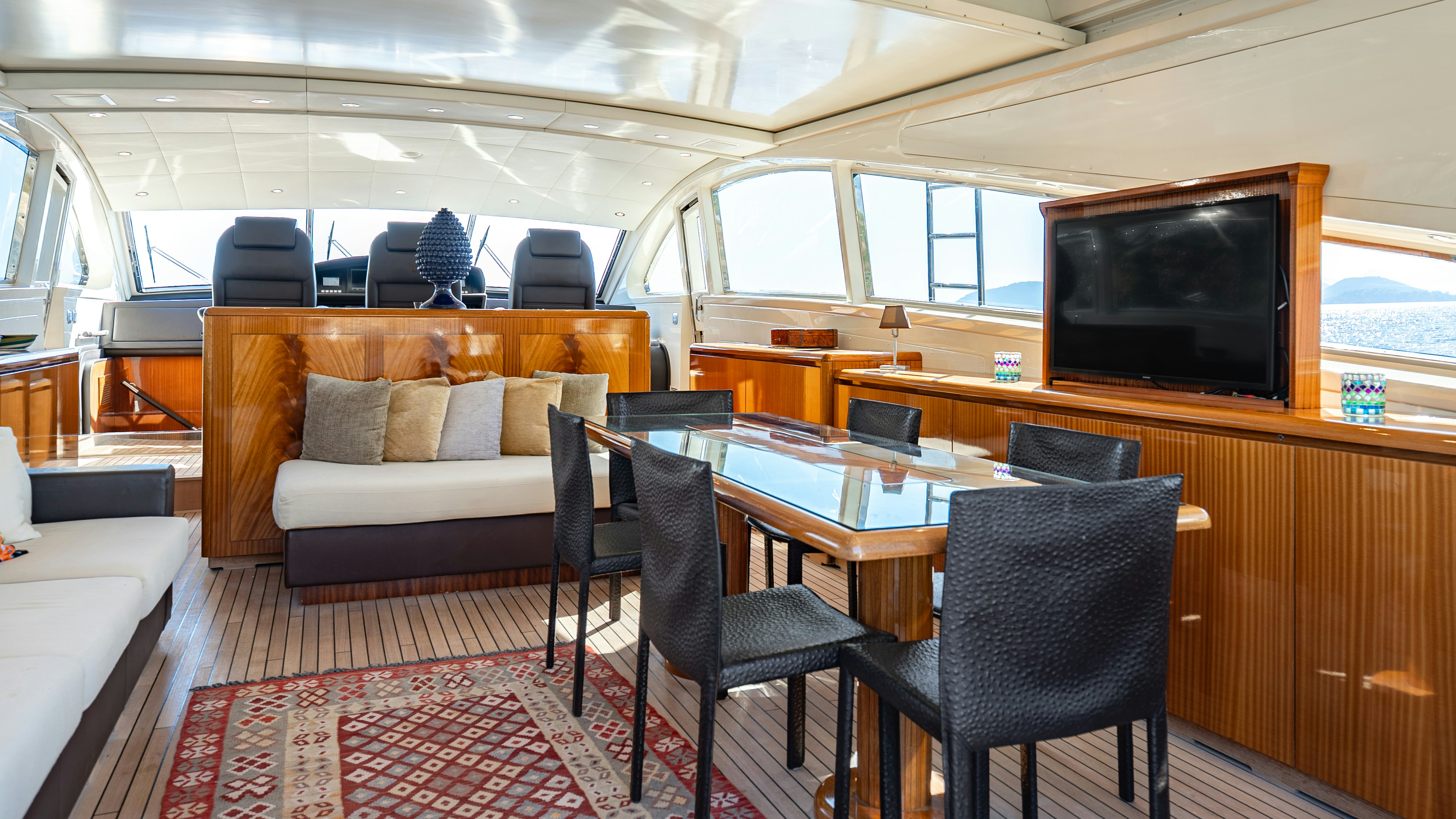 a living room with a table and chairs aboard CLARITA Yacht for Sale