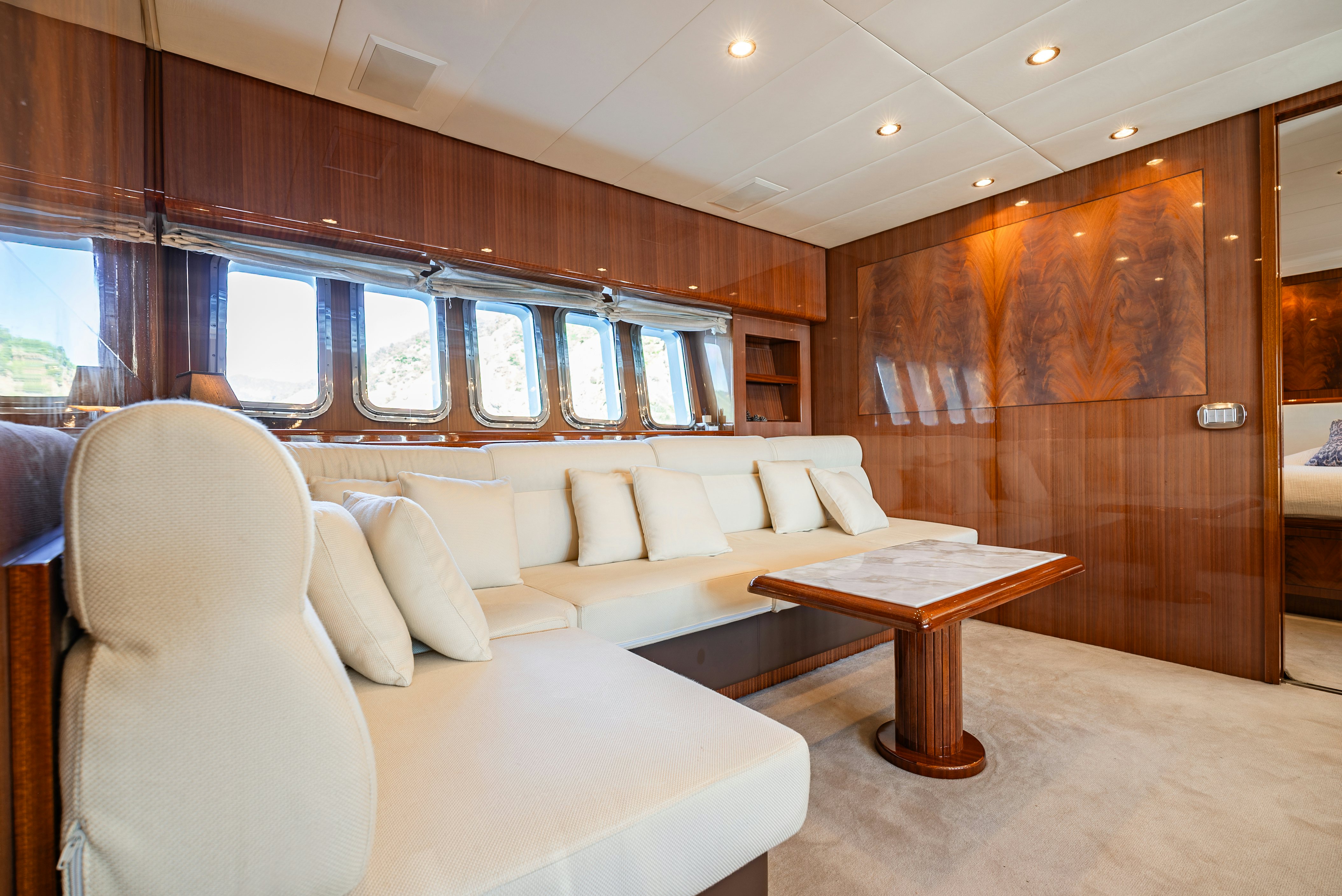 a living room with a couch and a table aboard CLARITA Yacht for Sale