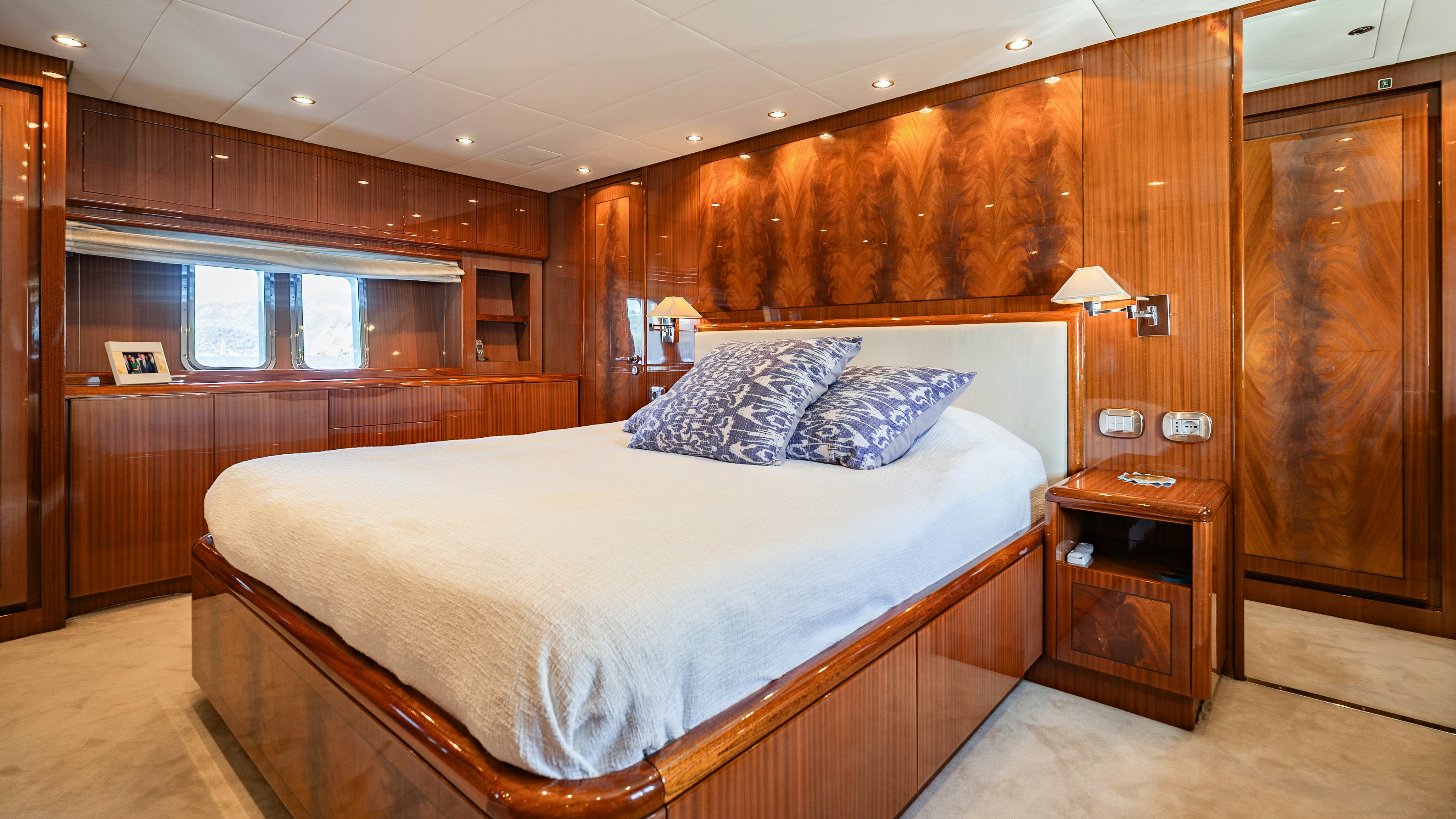 a bedroom with a bed and a desk aboard CLARITA Yacht for Sale