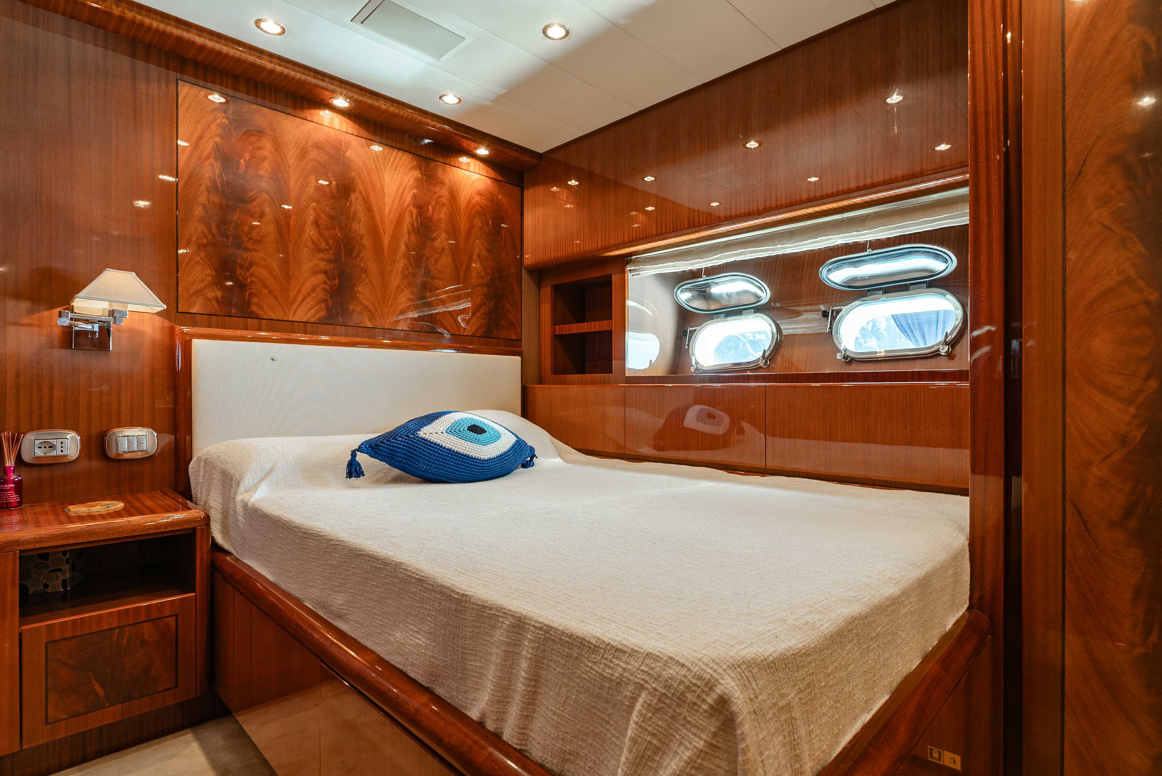 a bed with a blue pillow aboard CLARITA Yacht for Sale