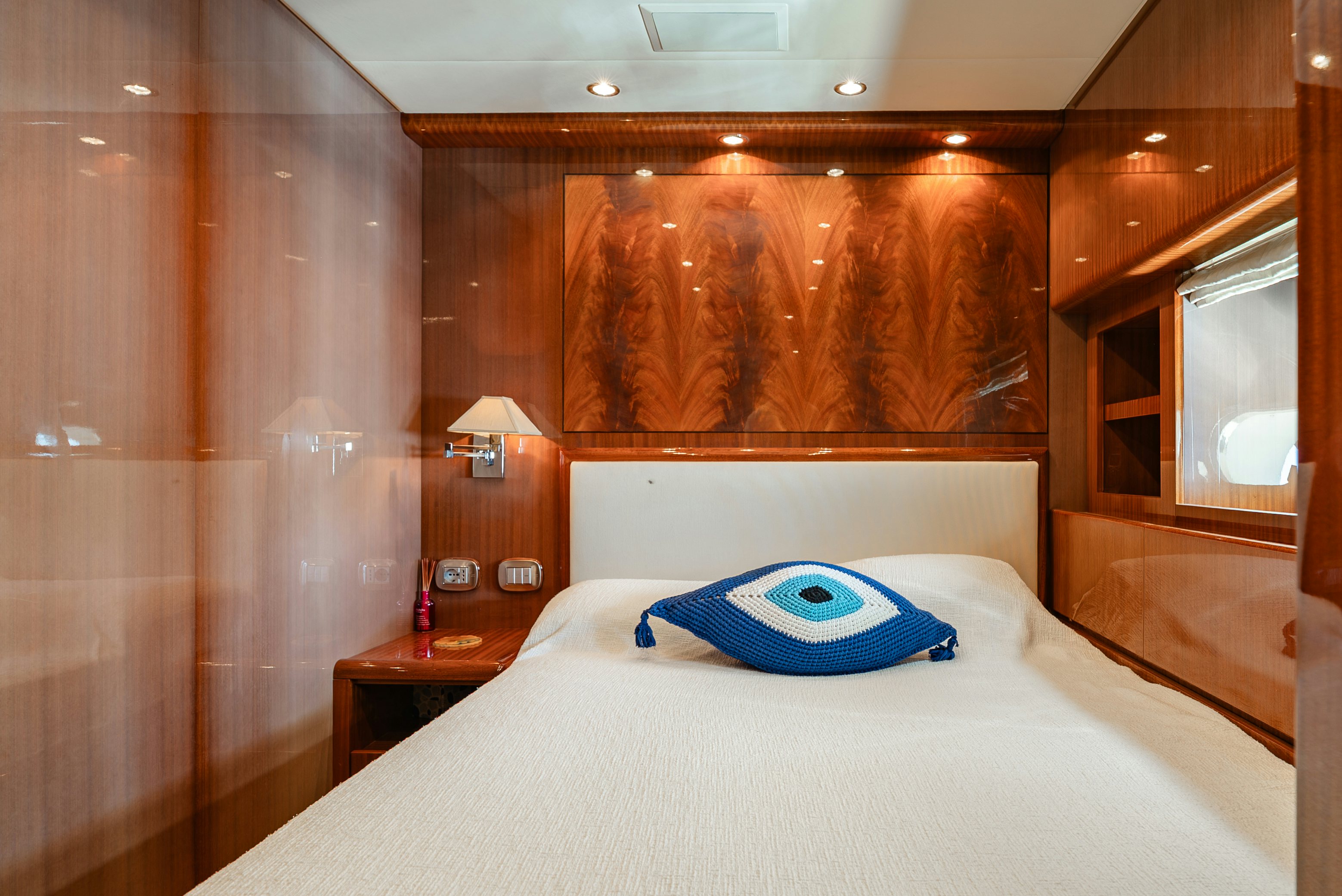 a bed with a blue pillow aboard CLARITA Yacht for Sale