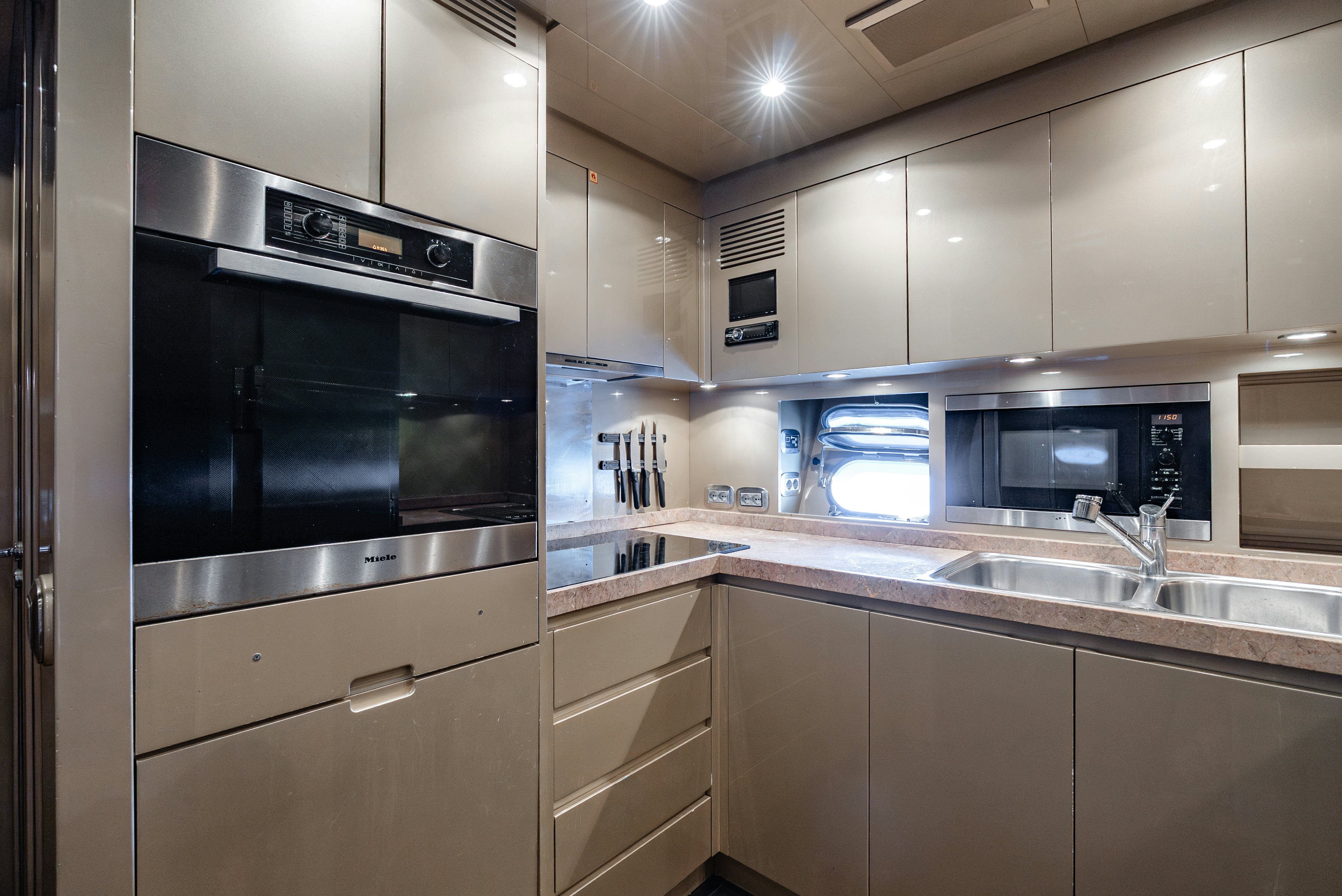 a kitchen with stainless steel appliances aboard CLARITA Yacht for Sale