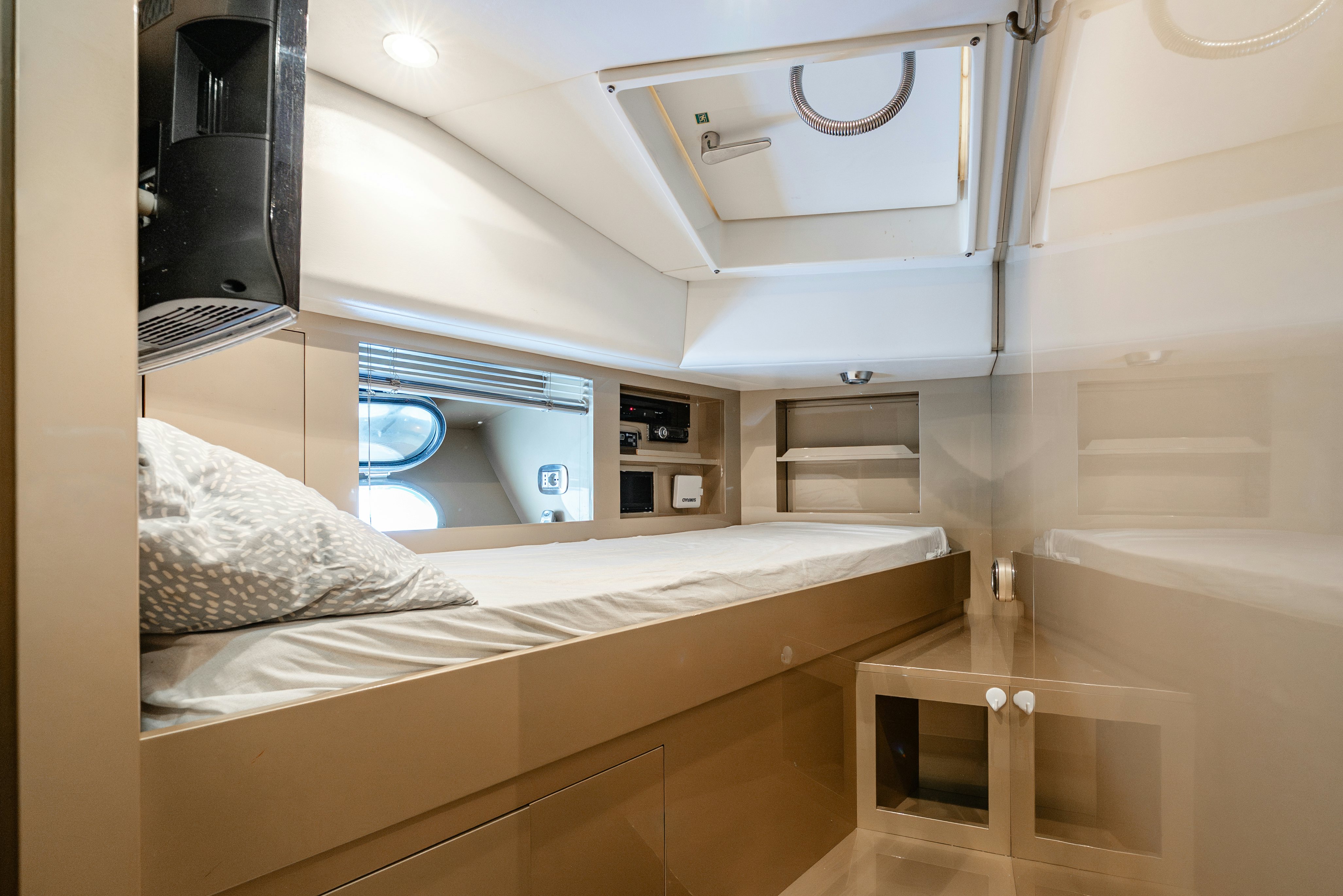 a bedroom with a bed and a desk aboard CLARITA Yacht for Sale