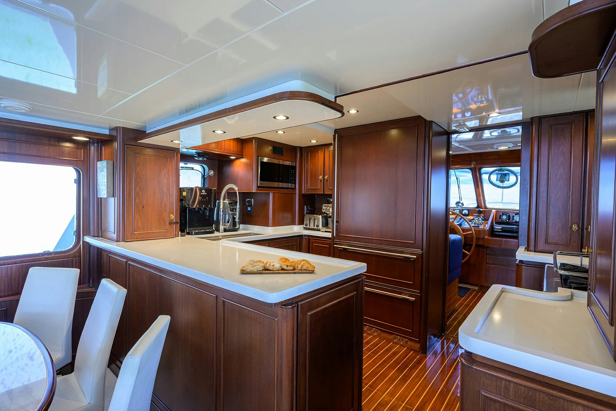 a kitchen with wooden cabinets aboard AVENTURER Yacht for Sale