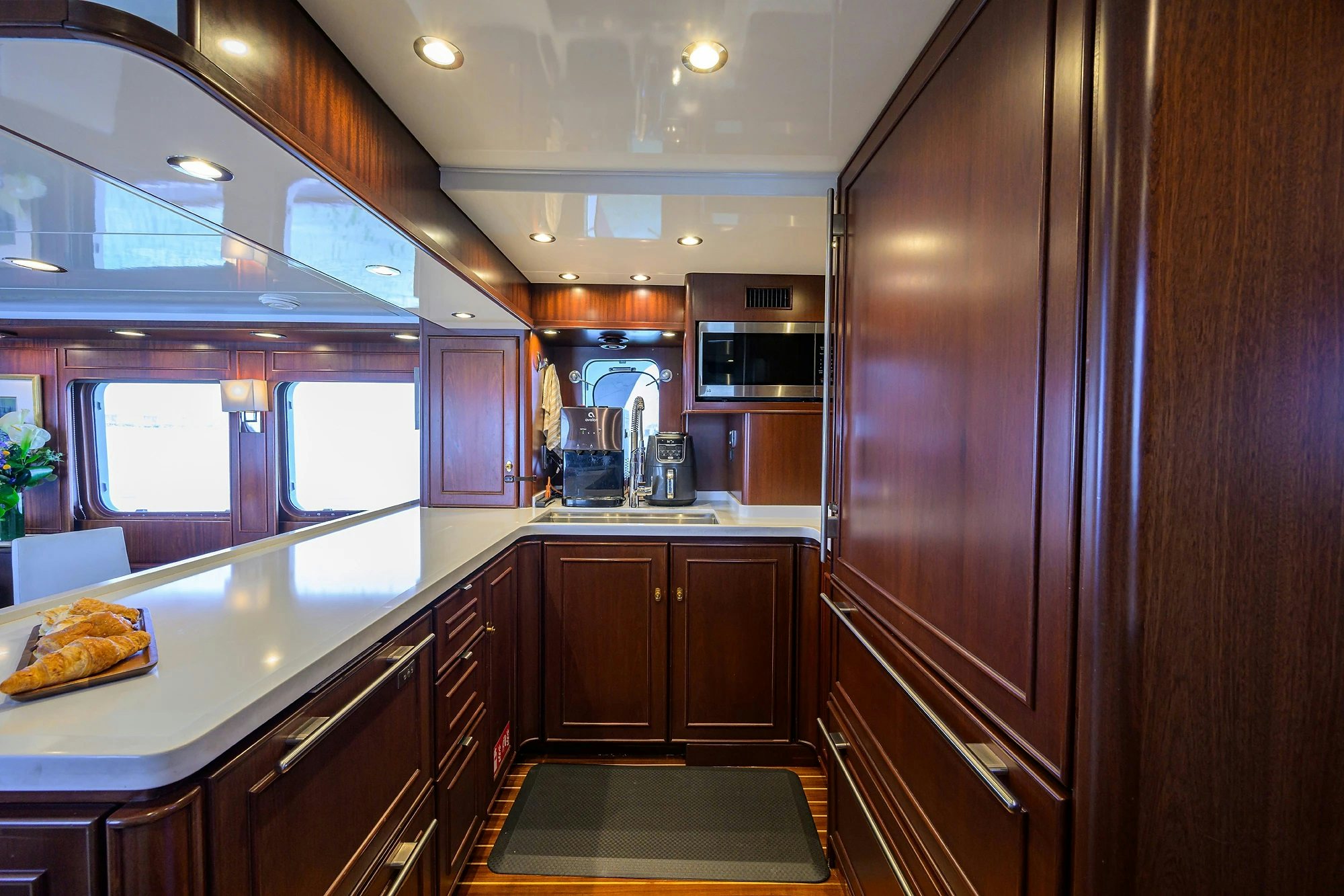 a kitchen with wooden cabinets aboard AVENTURER Yacht for Sale