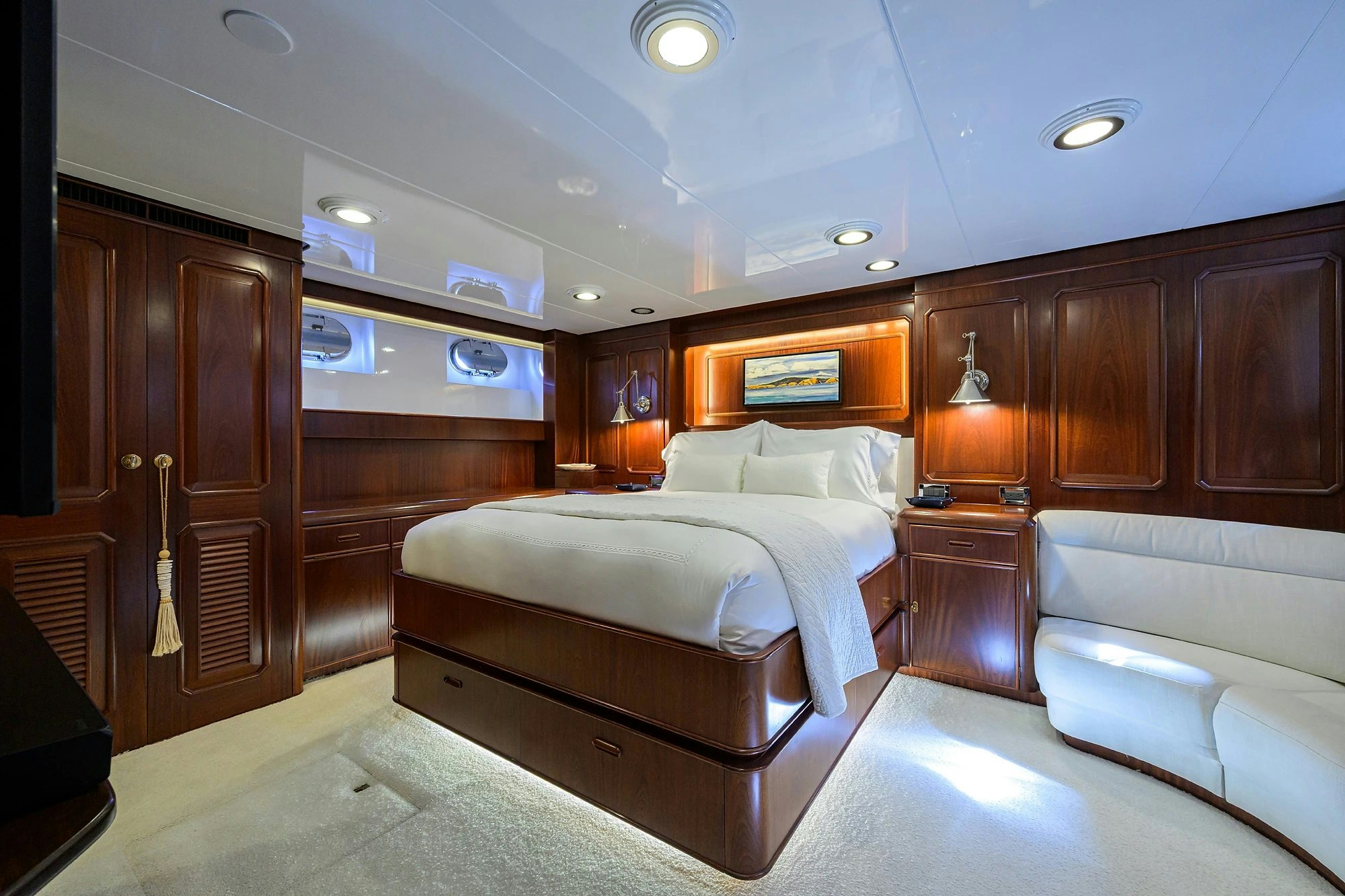 a bedroom with a bed and a couch aboard AVENTURER Yacht for Sale