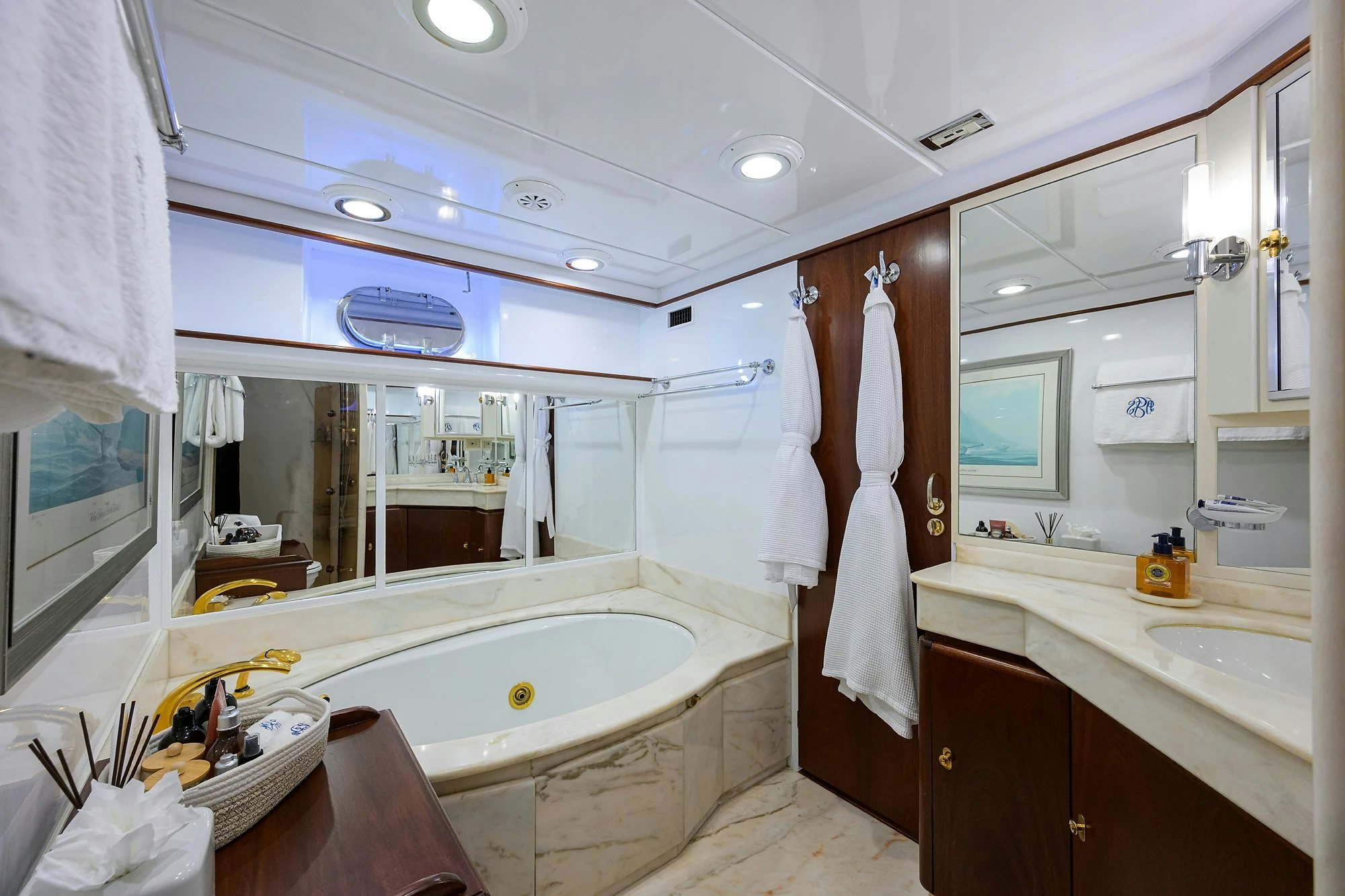 a bathroom with a tub sink and a sink aboard AVENTURER Yacht for Sale