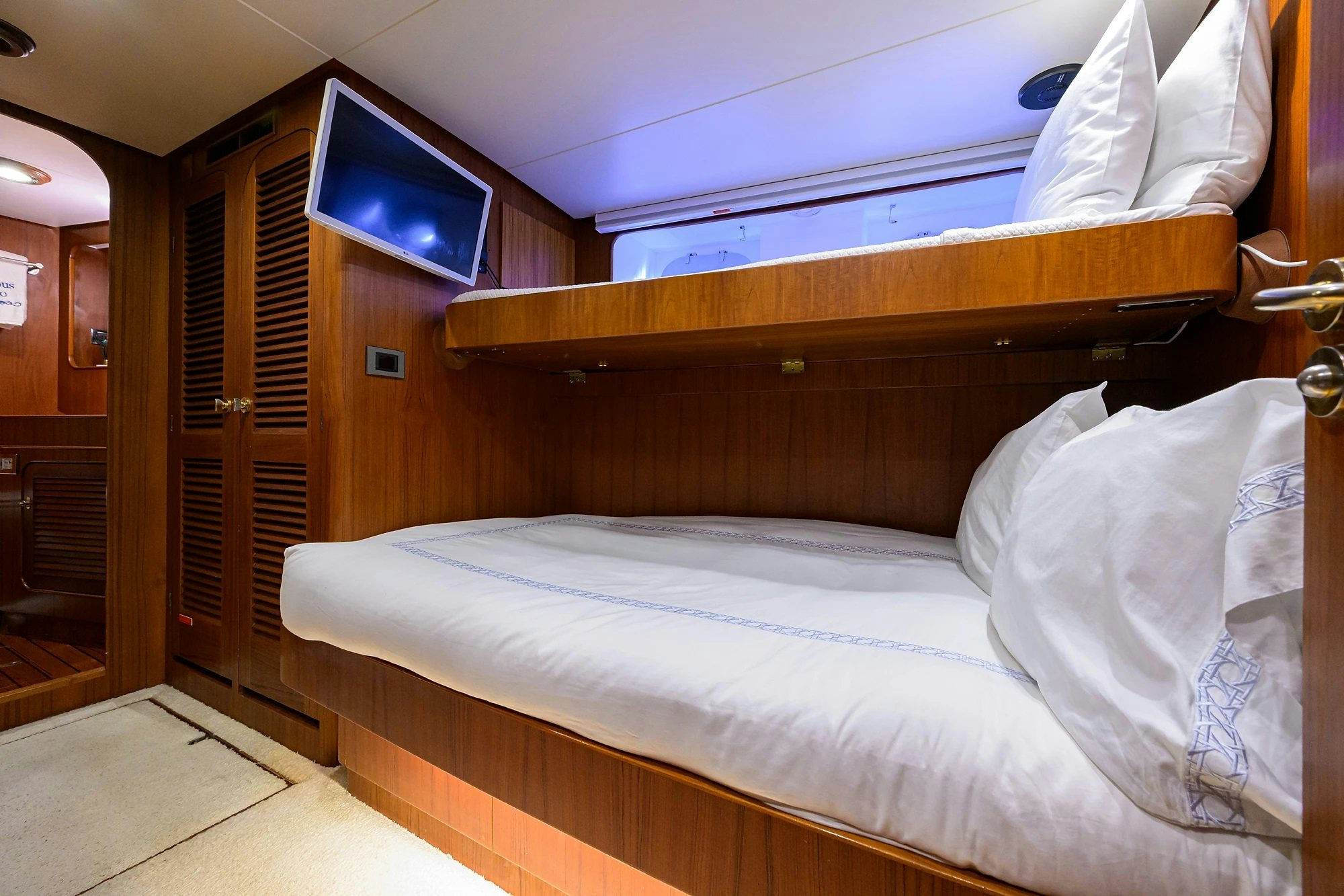 a bed with white sheets aboard AVENTURER Yacht for Sale
