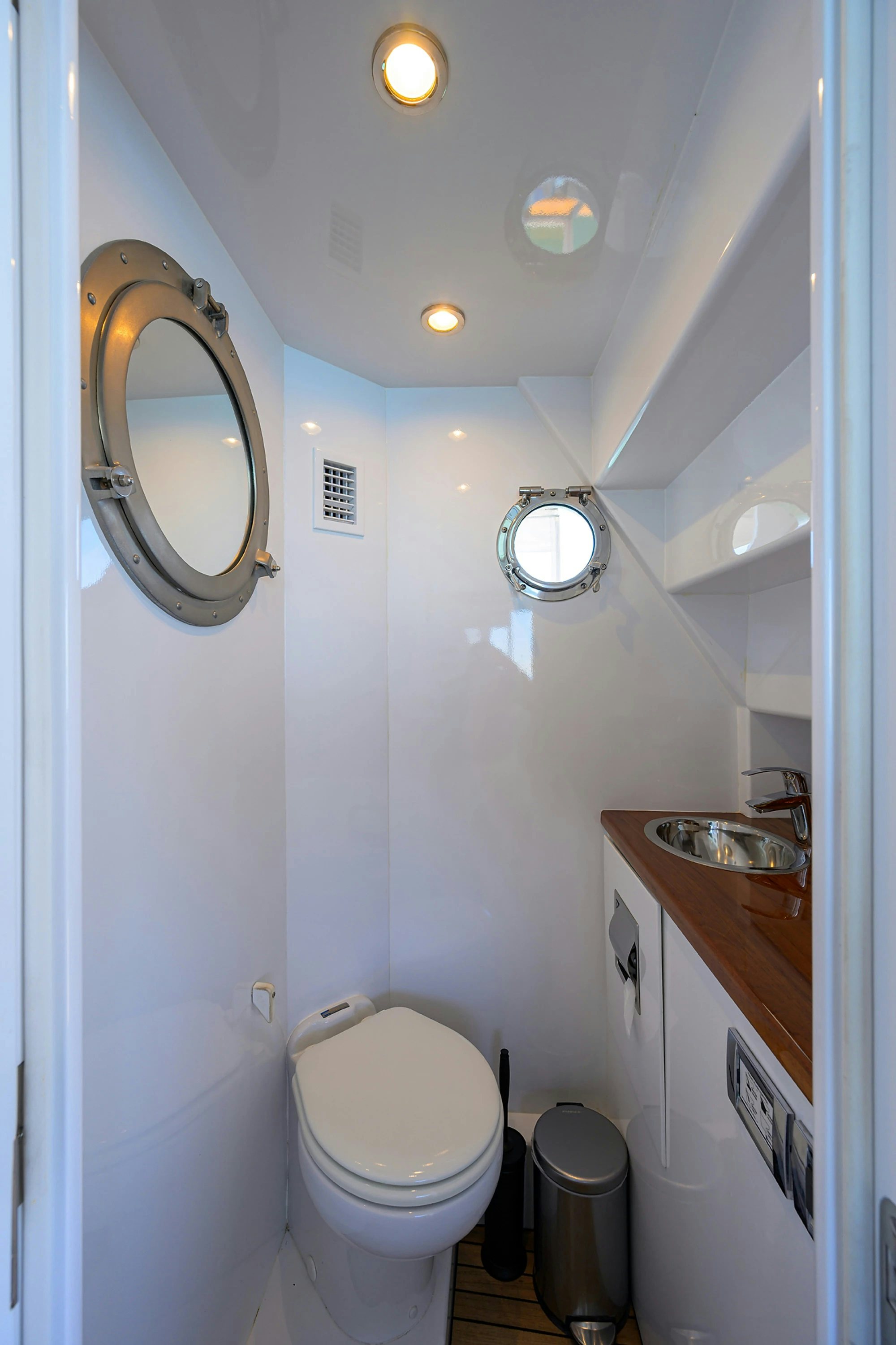 a bathroom with a toilet and a sink aboard AVENTURER Yacht for Sale