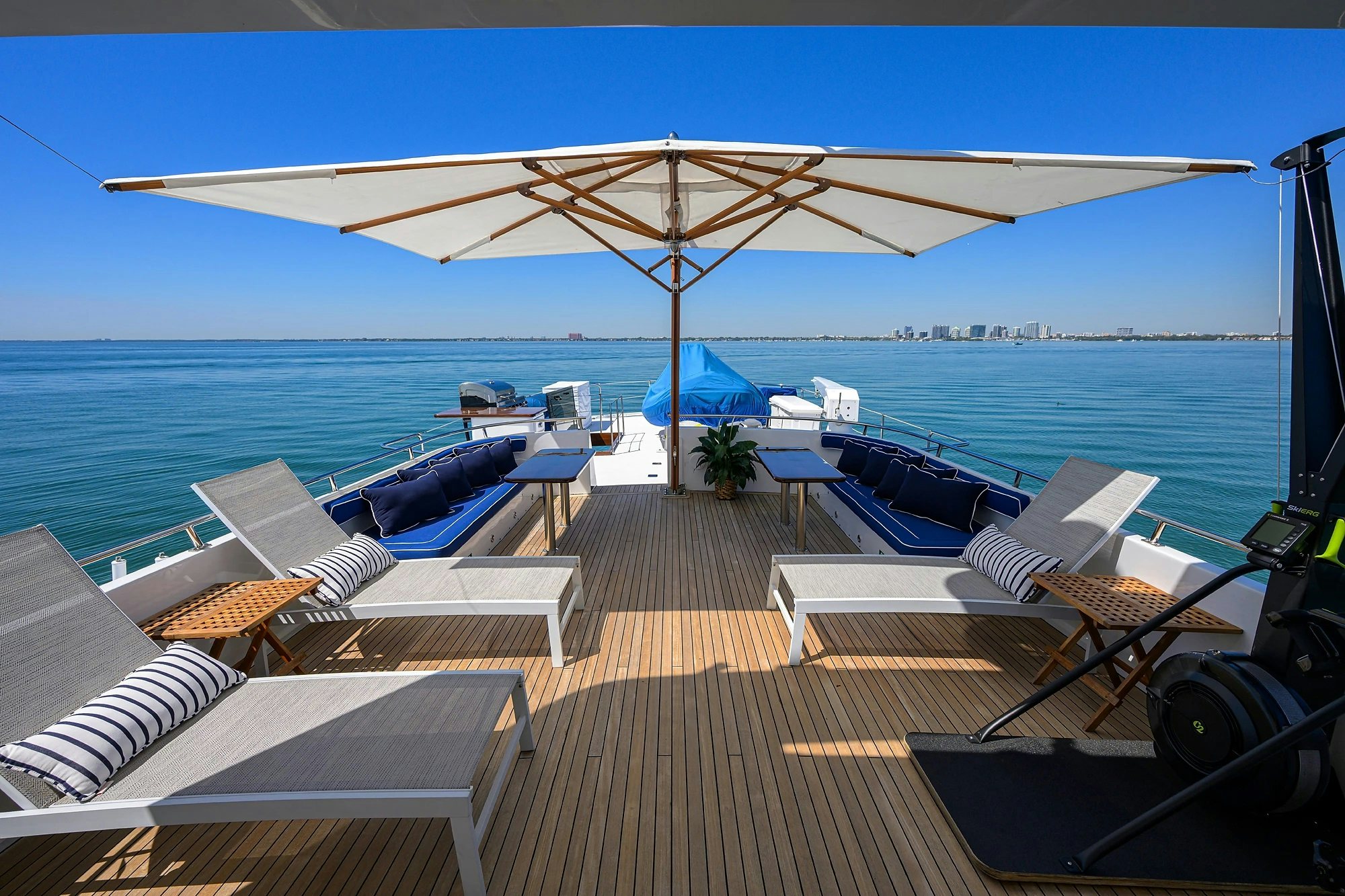 a deck with a large pool and a large umbrella aboard AVENTURER Yacht for Sale