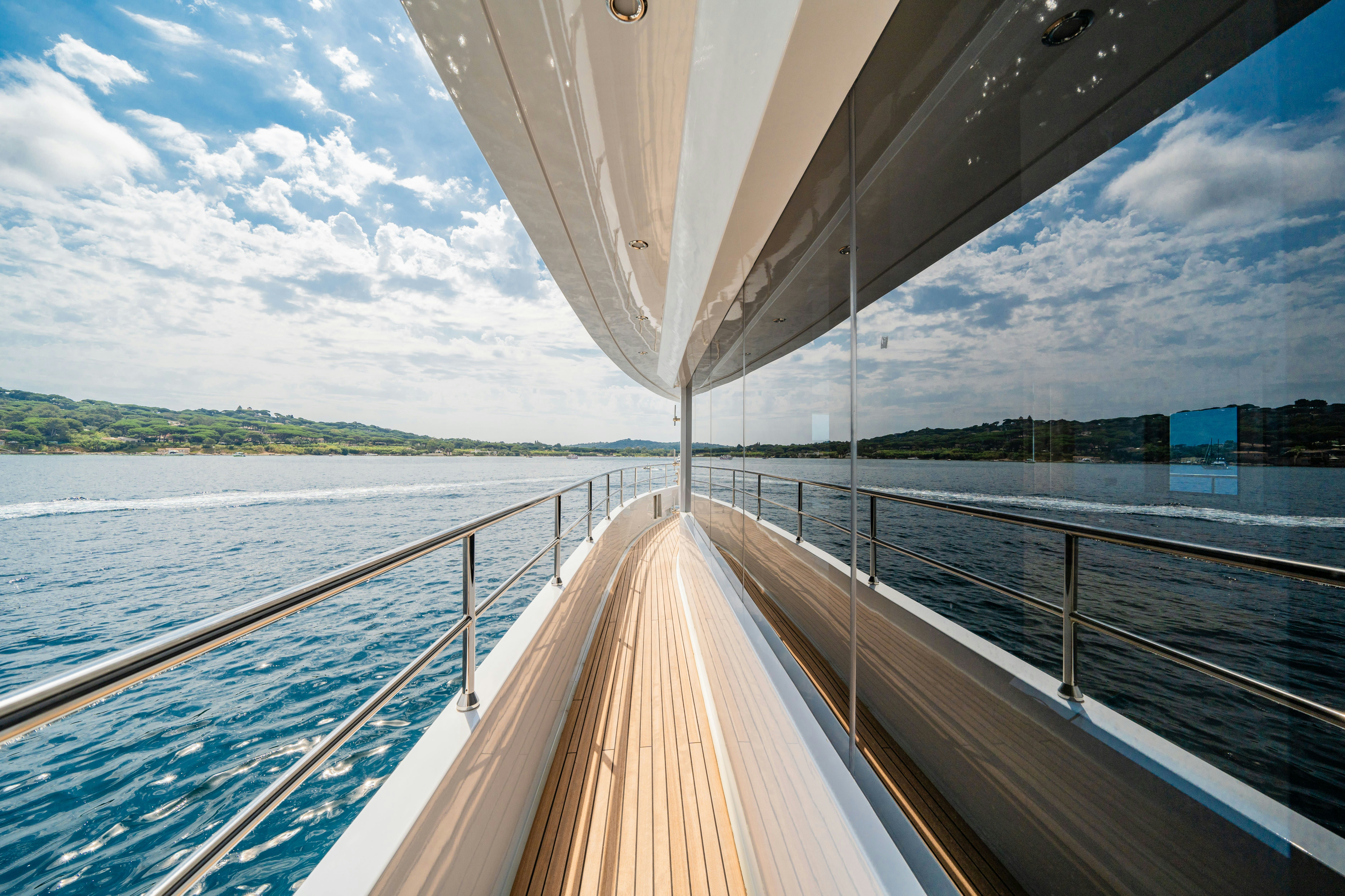 a large white boat on a body of water aboard ICE Yacht for Sale