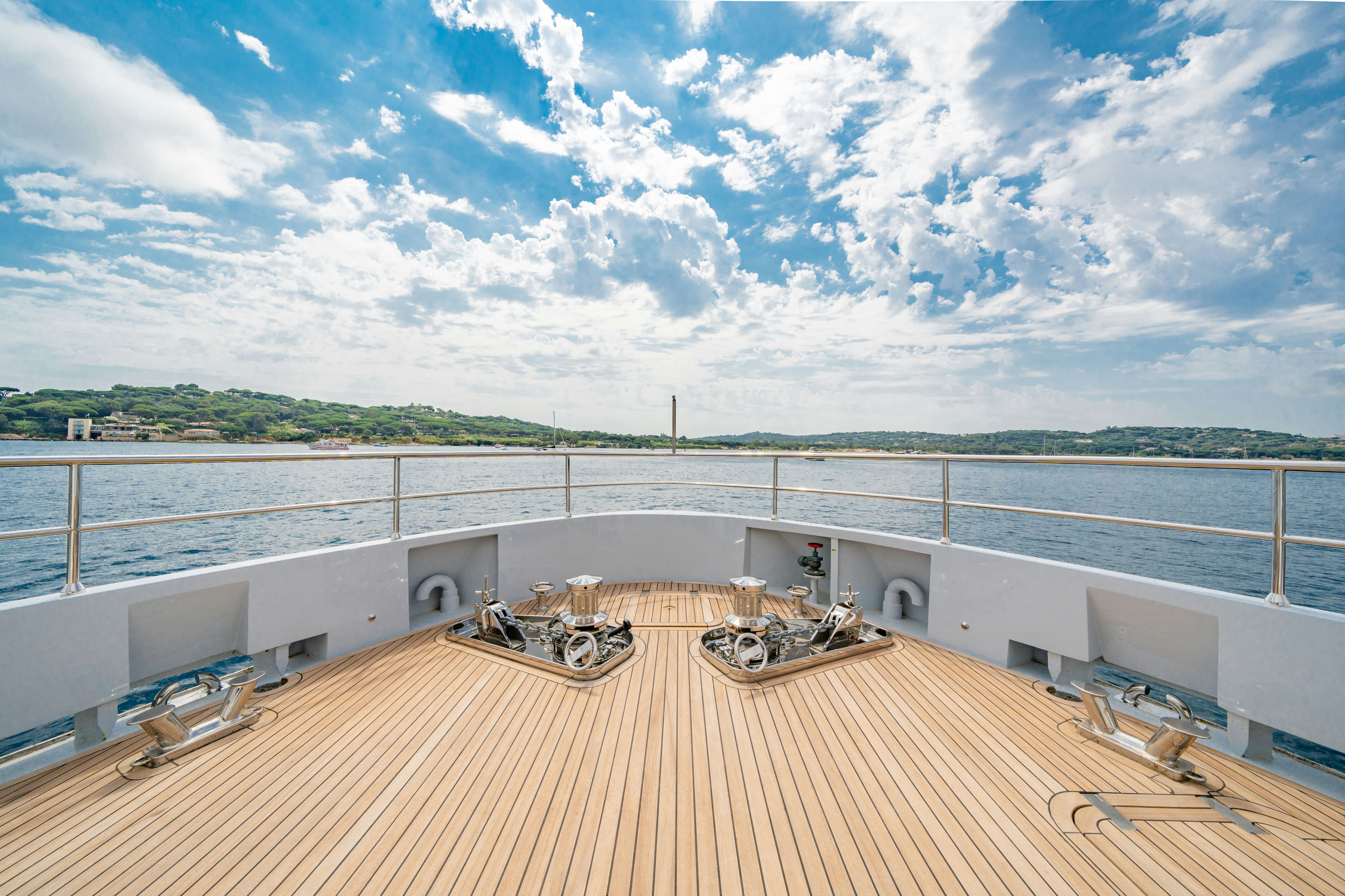 a deck with a large body of water and a large boat on it aboard ICE Yacht for Sale