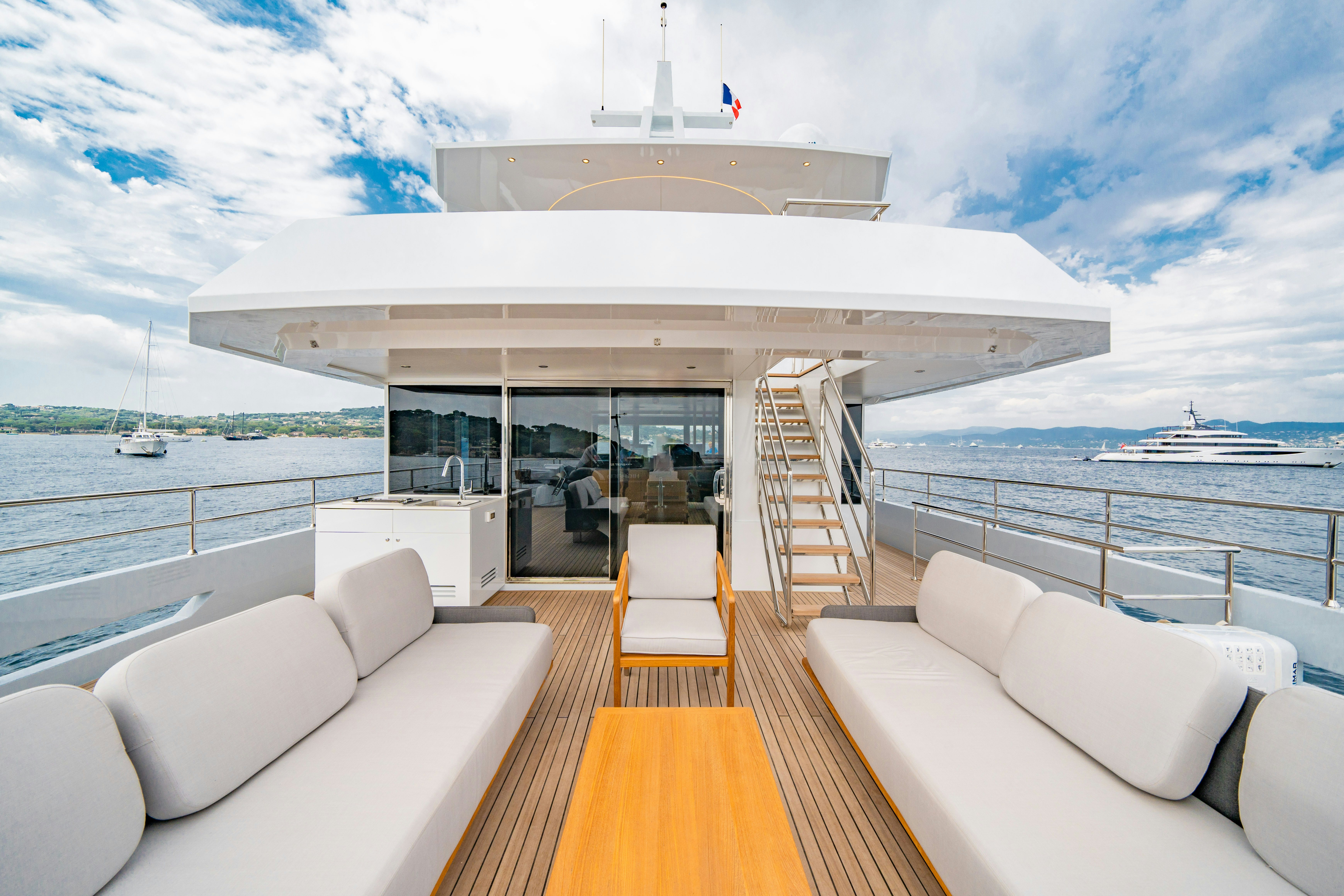 a large white building with a white roof and a large body of water aboard ICE Yacht for Sale