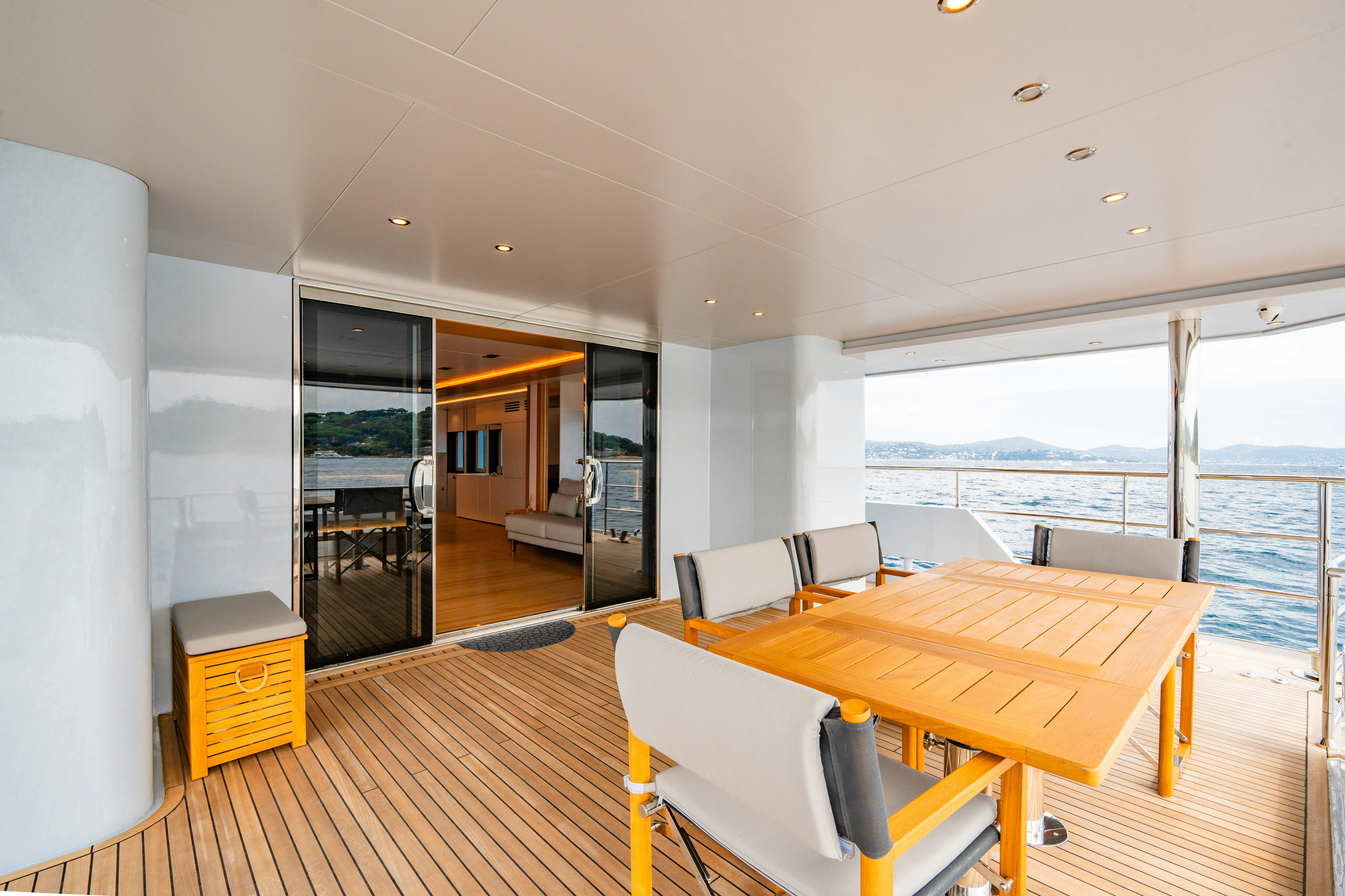 a room with a table and chairs aboard ICE Yacht for Sale