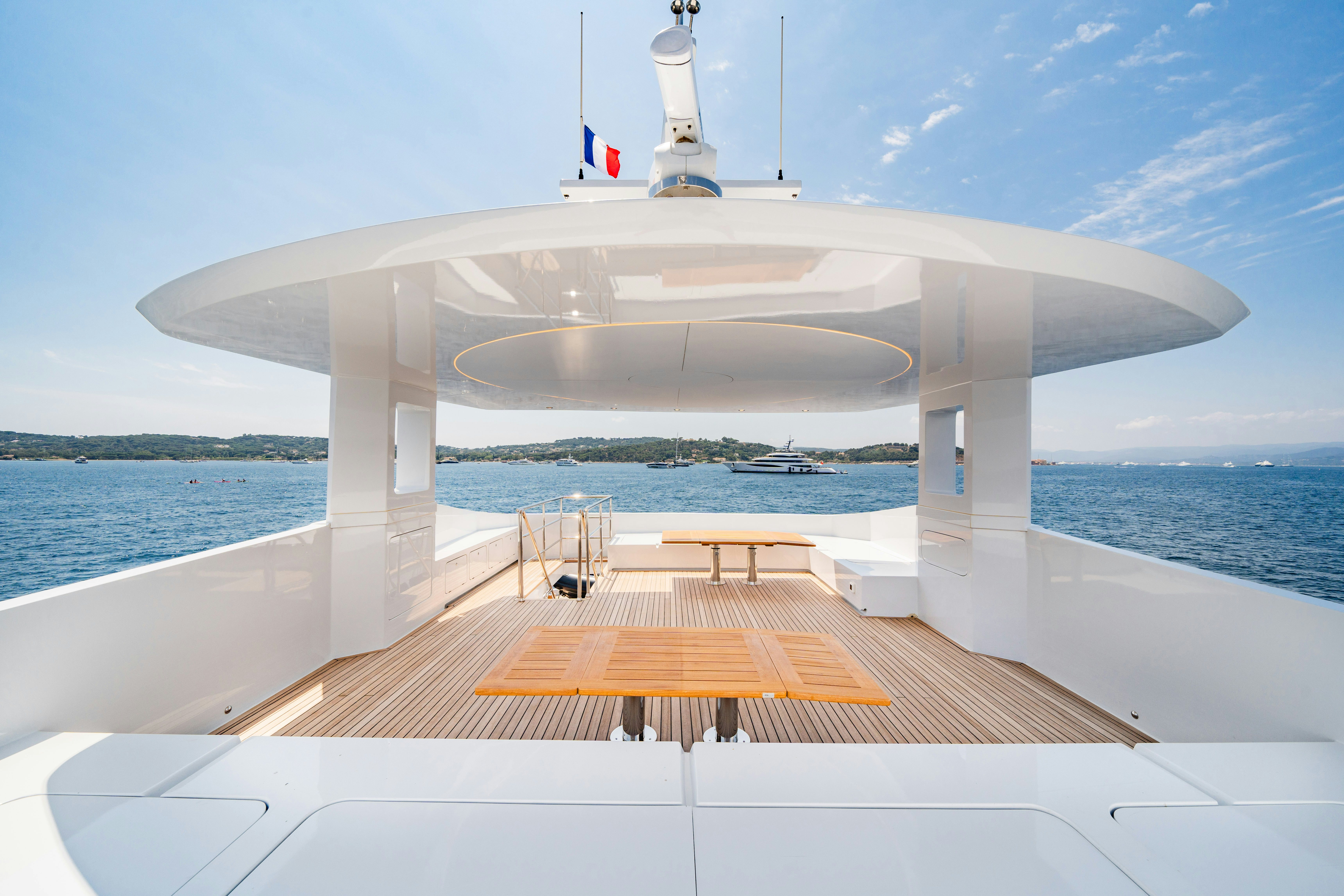 a white building with a tower on a boat in the water aboard ICE Yacht for Sale