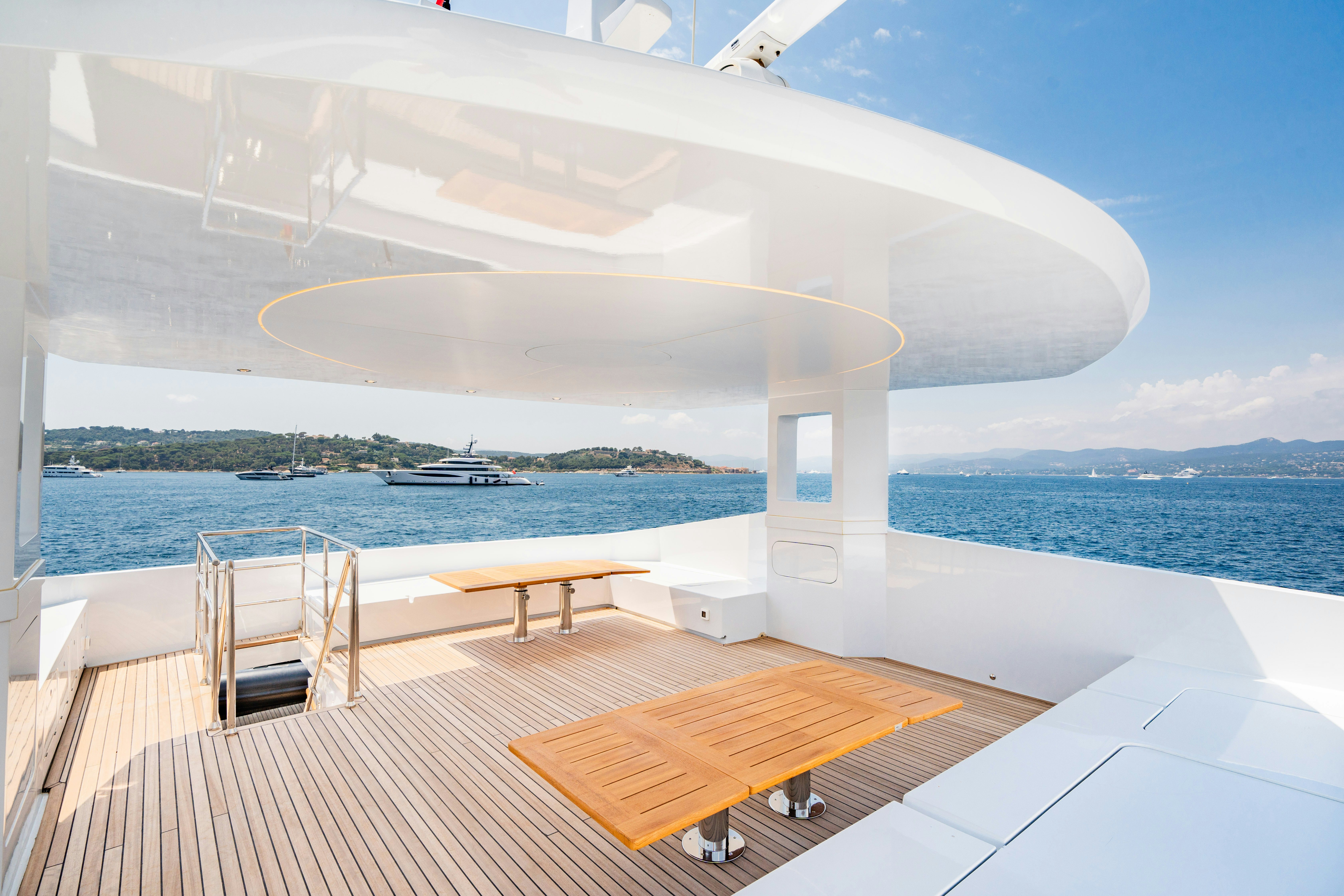 a large white building by the water aboard ICE Yacht for Sale