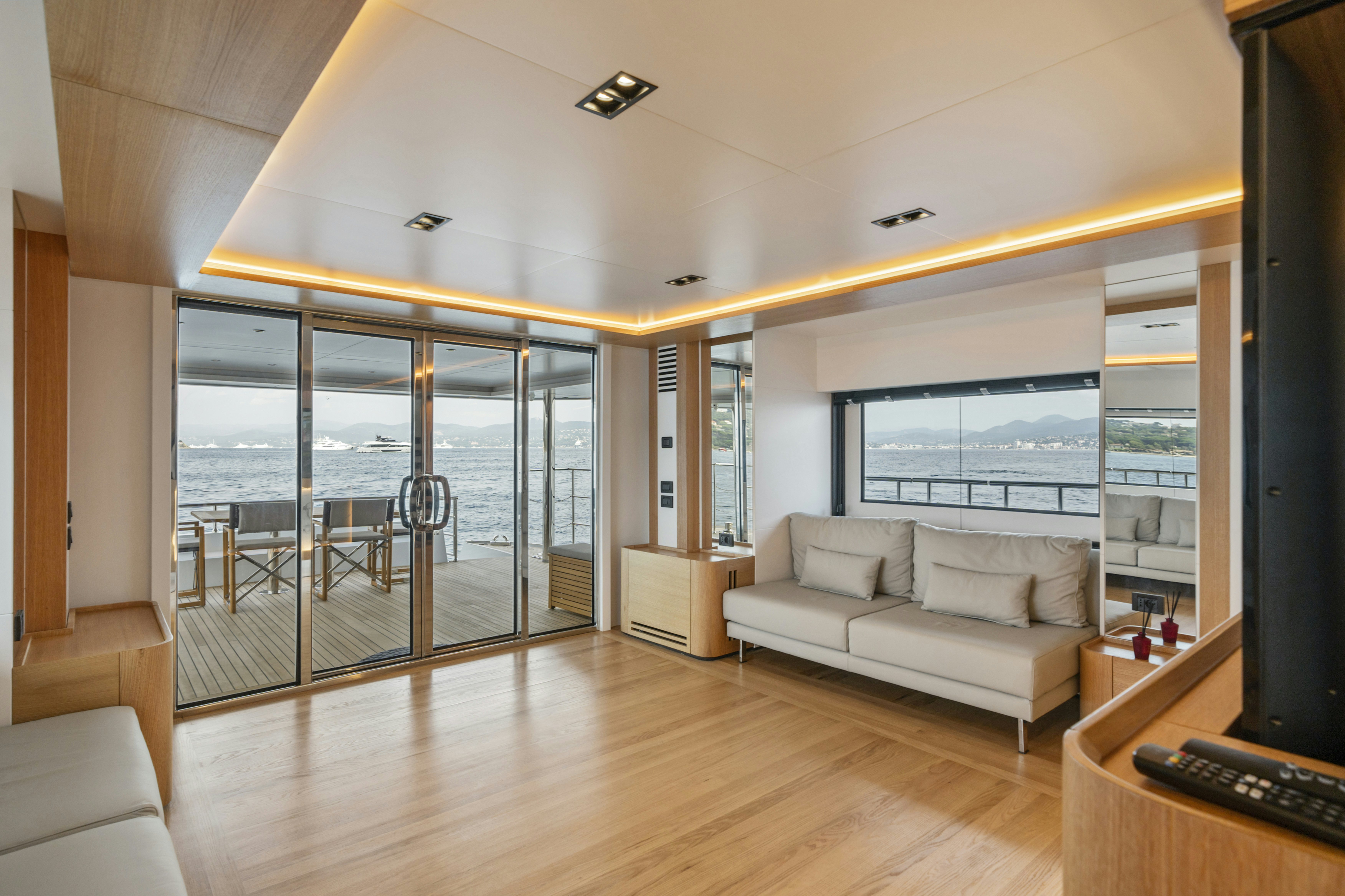 a living room with a large glass door aboard ICE Yacht for Sale