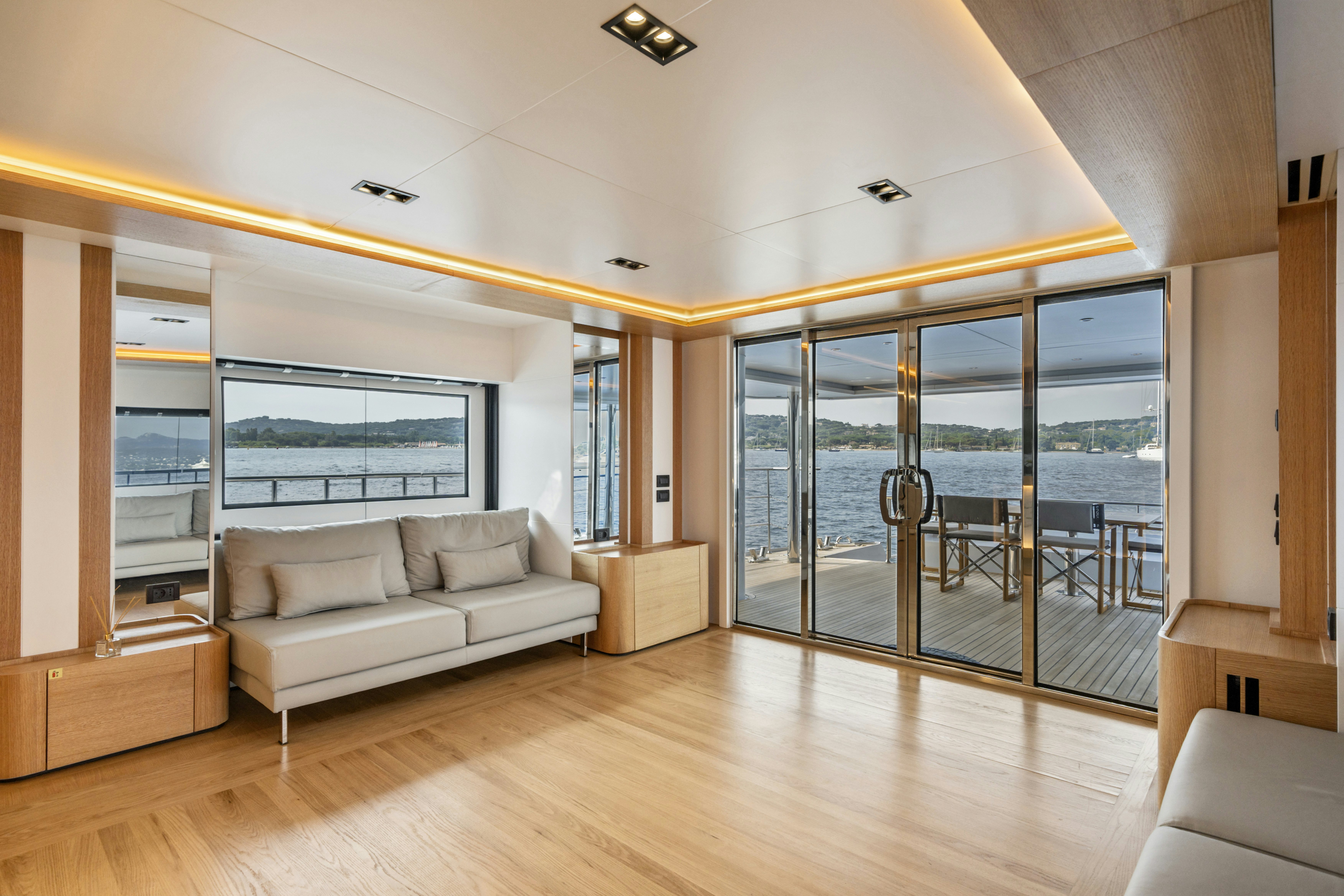 a living room with a large glass door aboard ICE Yacht for Sale