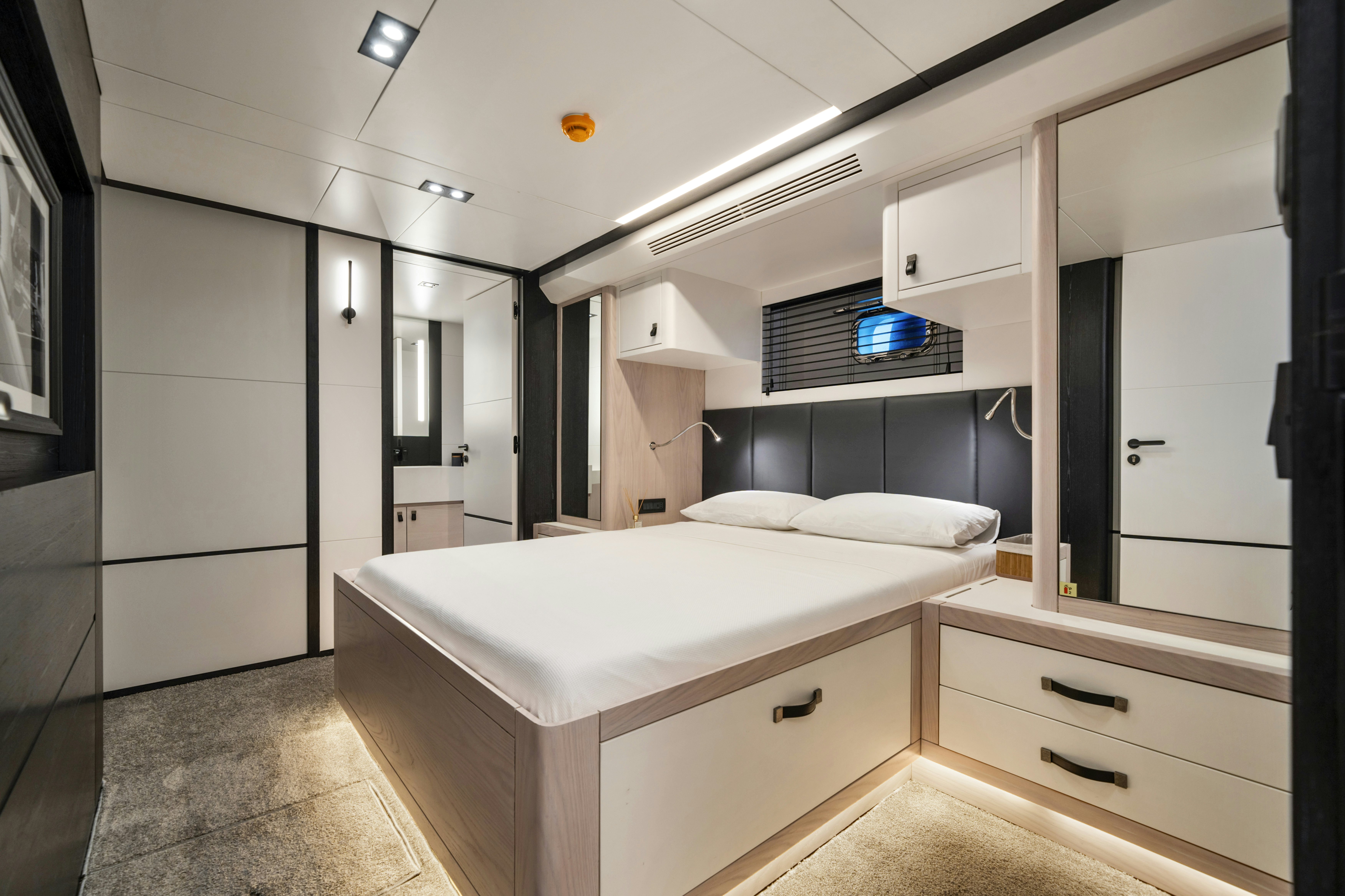 a room with a bed and a desk aboard ICE Yacht for Sale