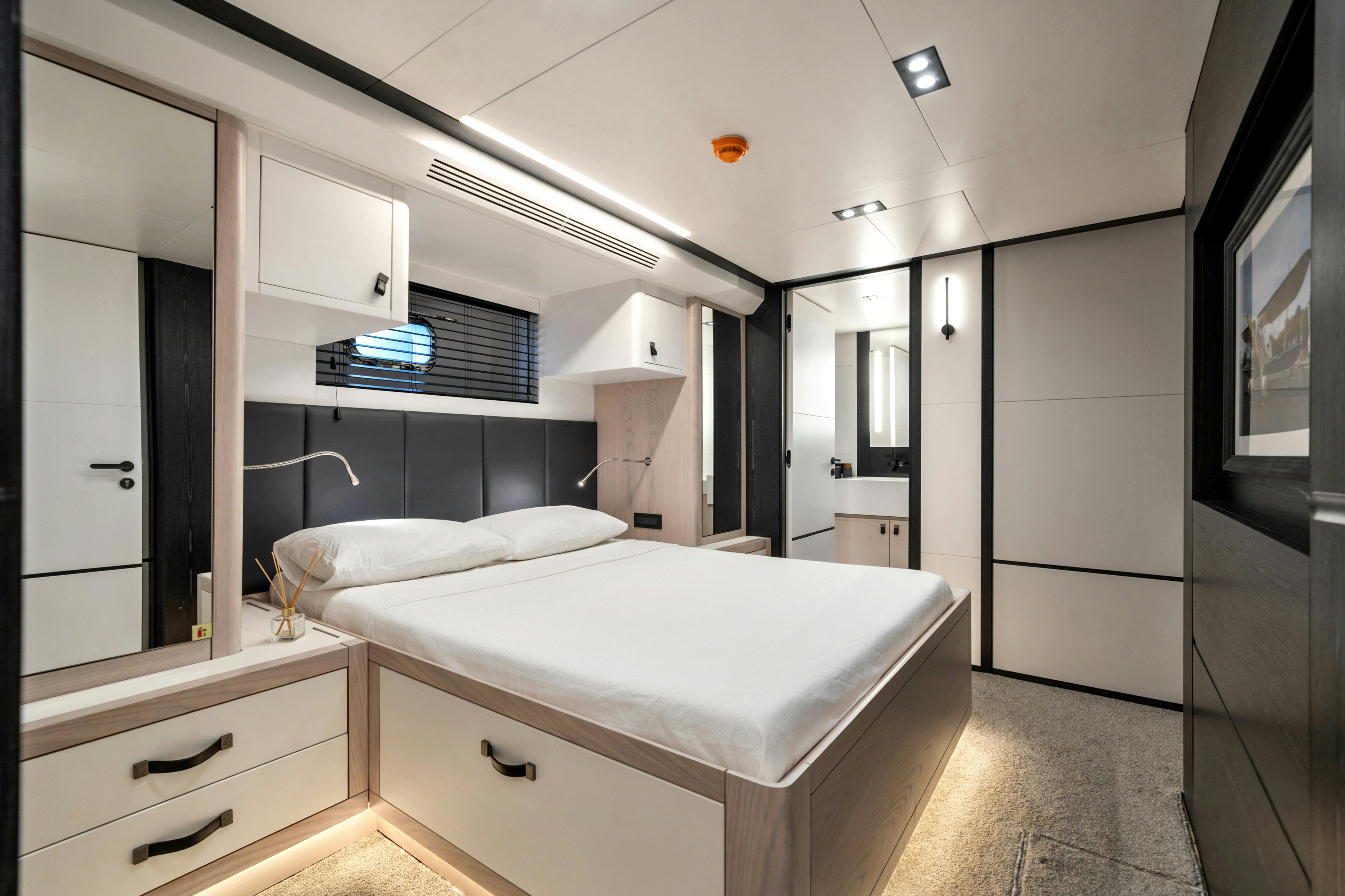 a bedroom with a bed aboard ICE Yacht for Sale