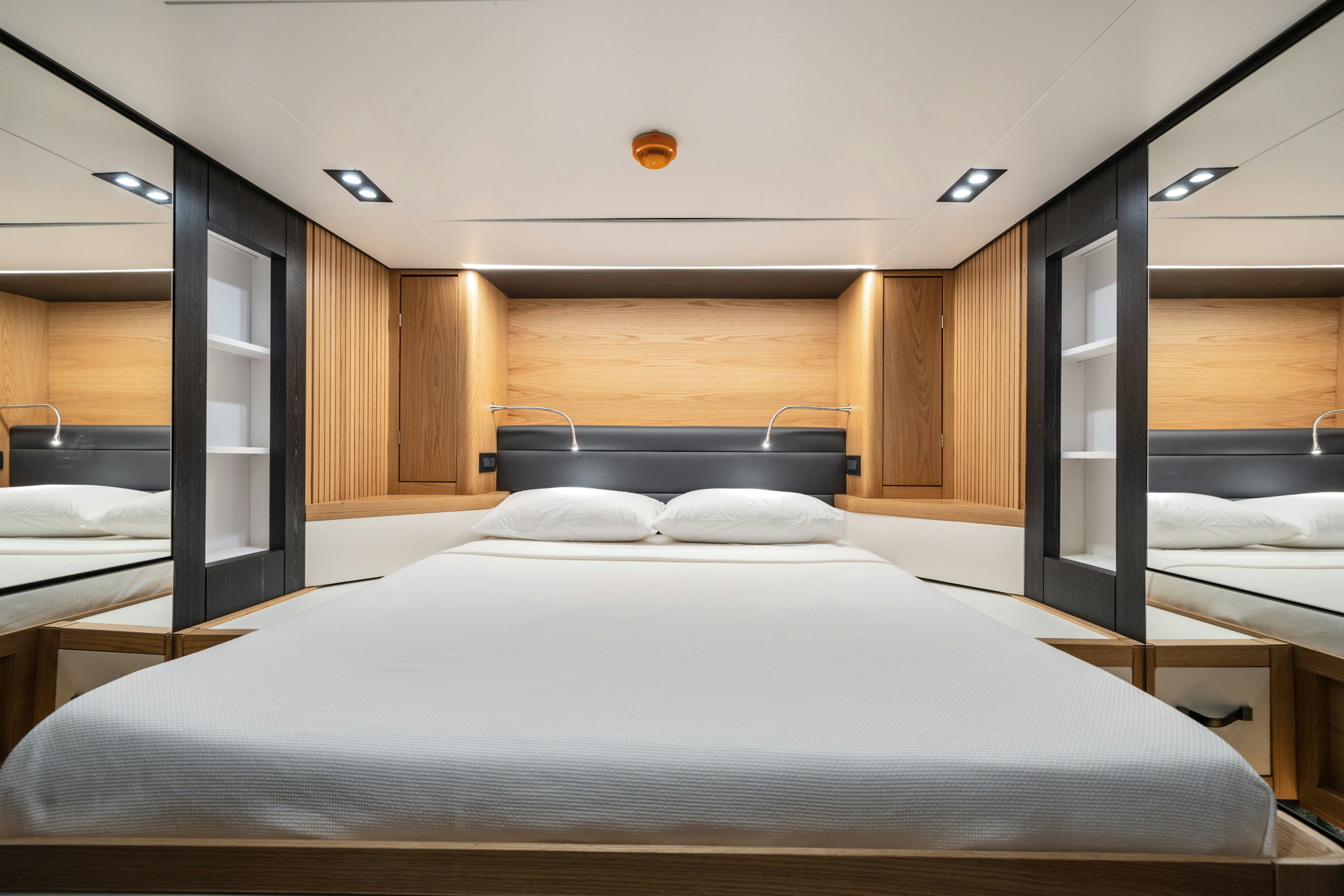 a room with a bed and a desk aboard ICE Yacht for Sale