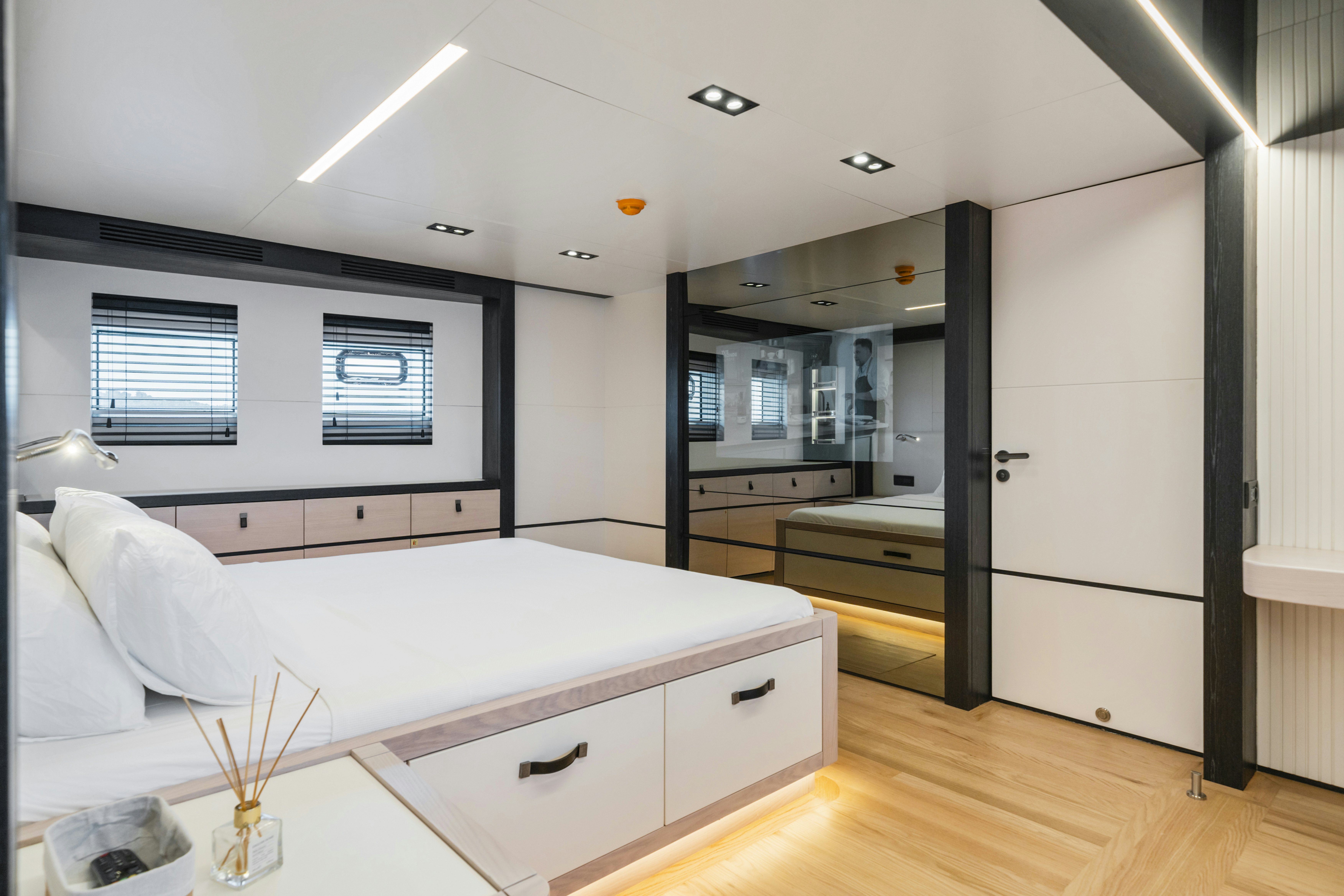 a bedroom with a large bed aboard ICE Yacht for Sale