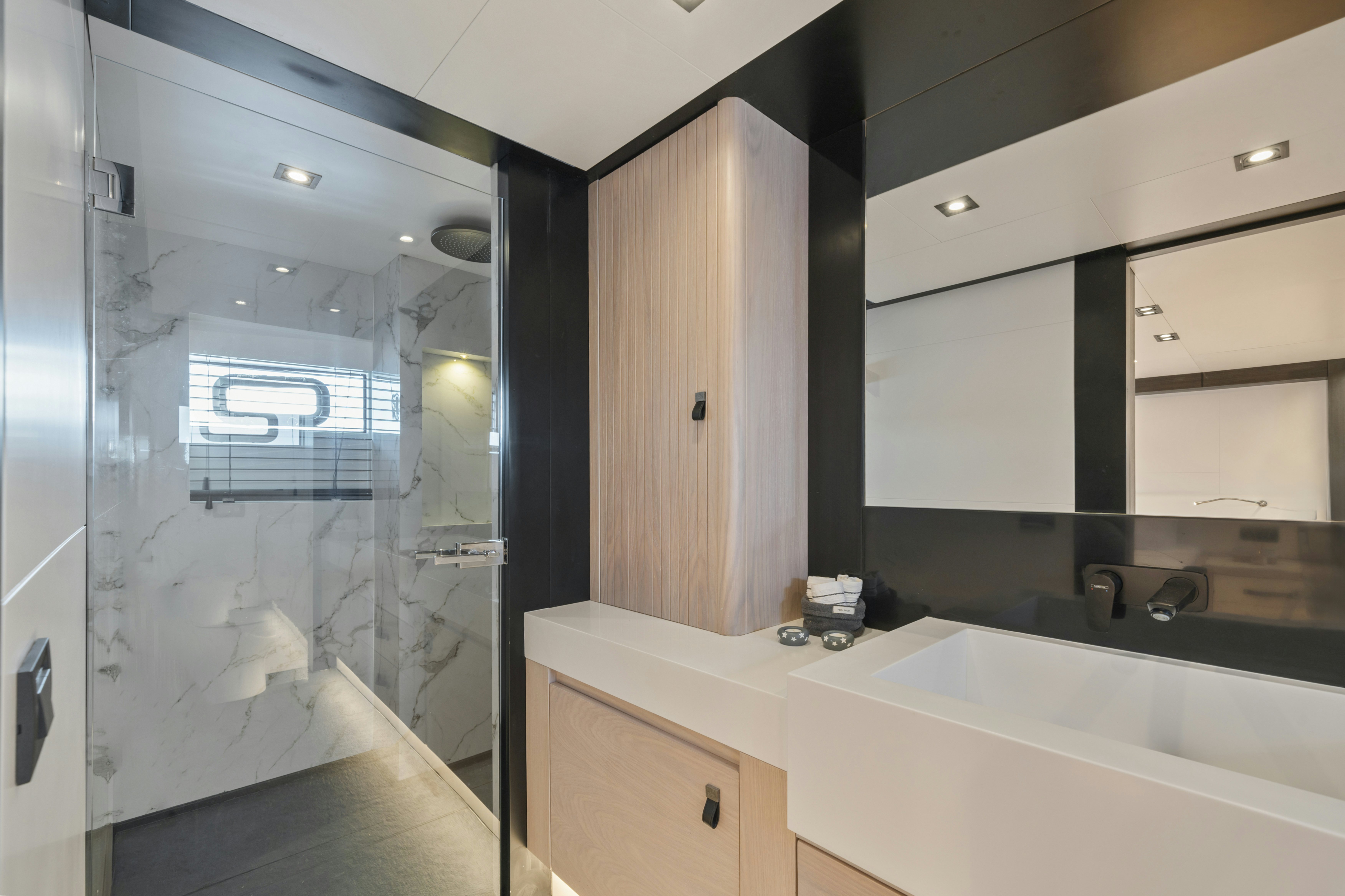 a bathroom with a large mirror aboard ICE Yacht for Sale
