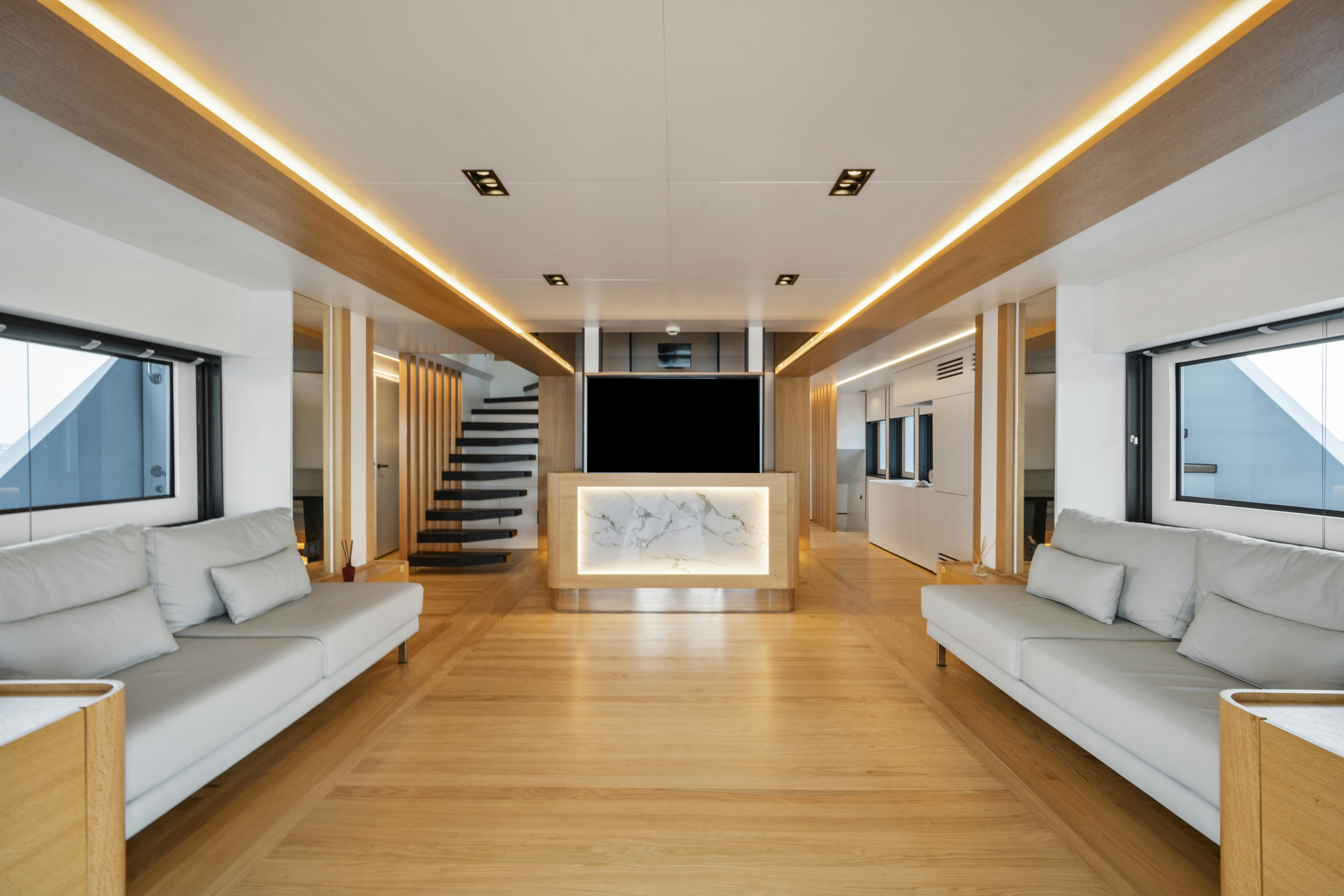 a living room with a wood floor aboard ICE Yacht for Sale