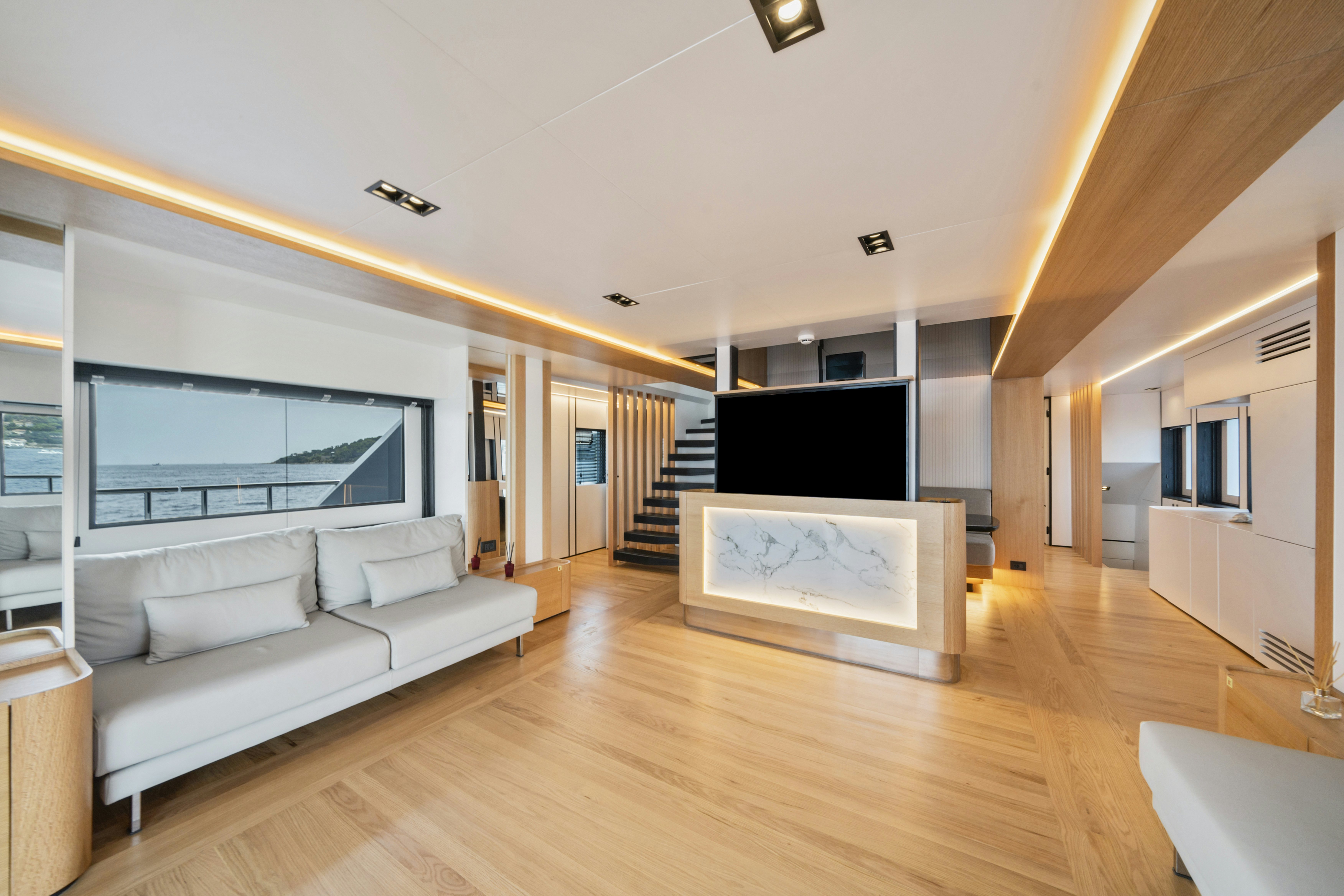 a living room with a large screen aboard ICE Yacht for Sale