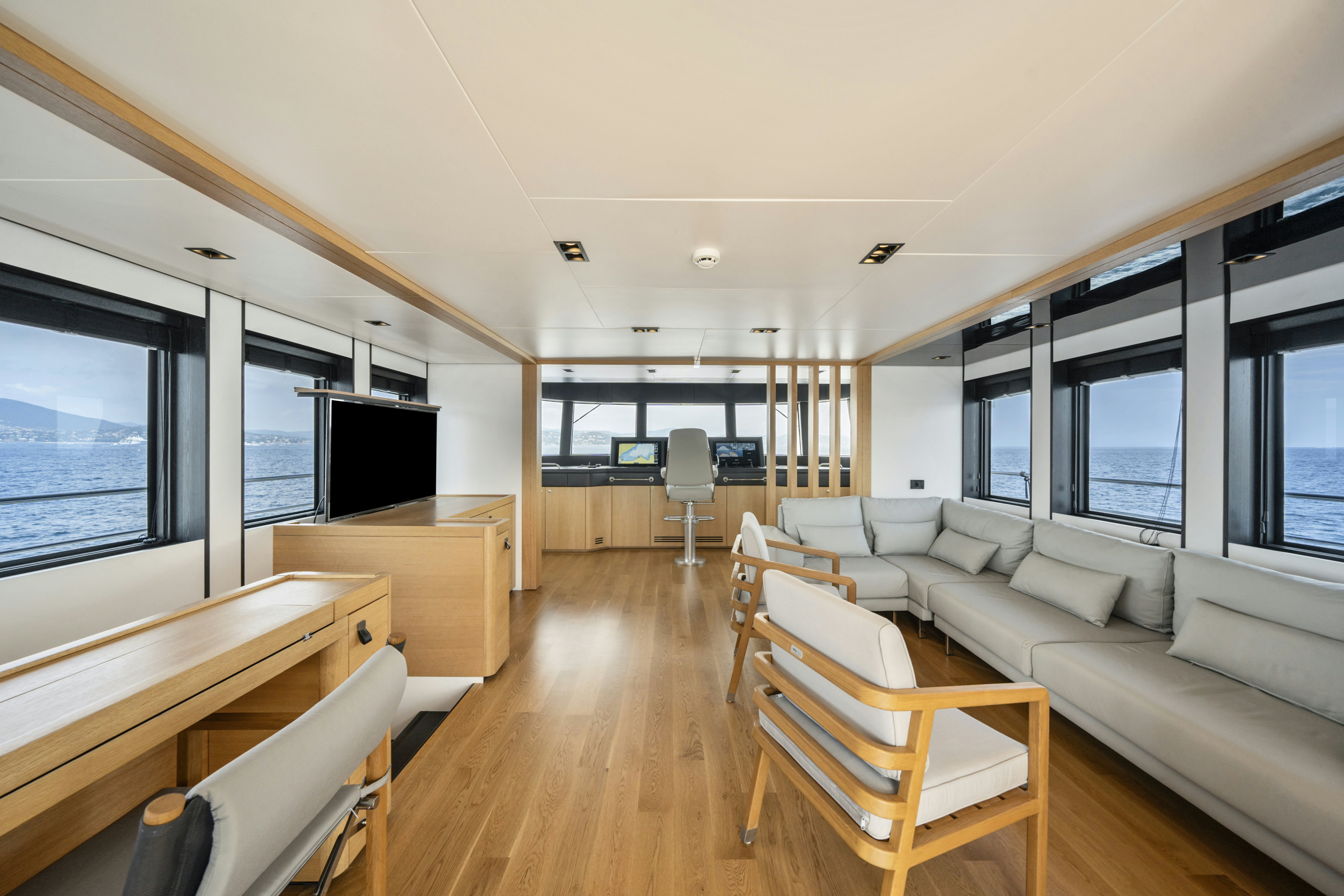 a living room with a wood floor aboard ICE Yacht for Sale