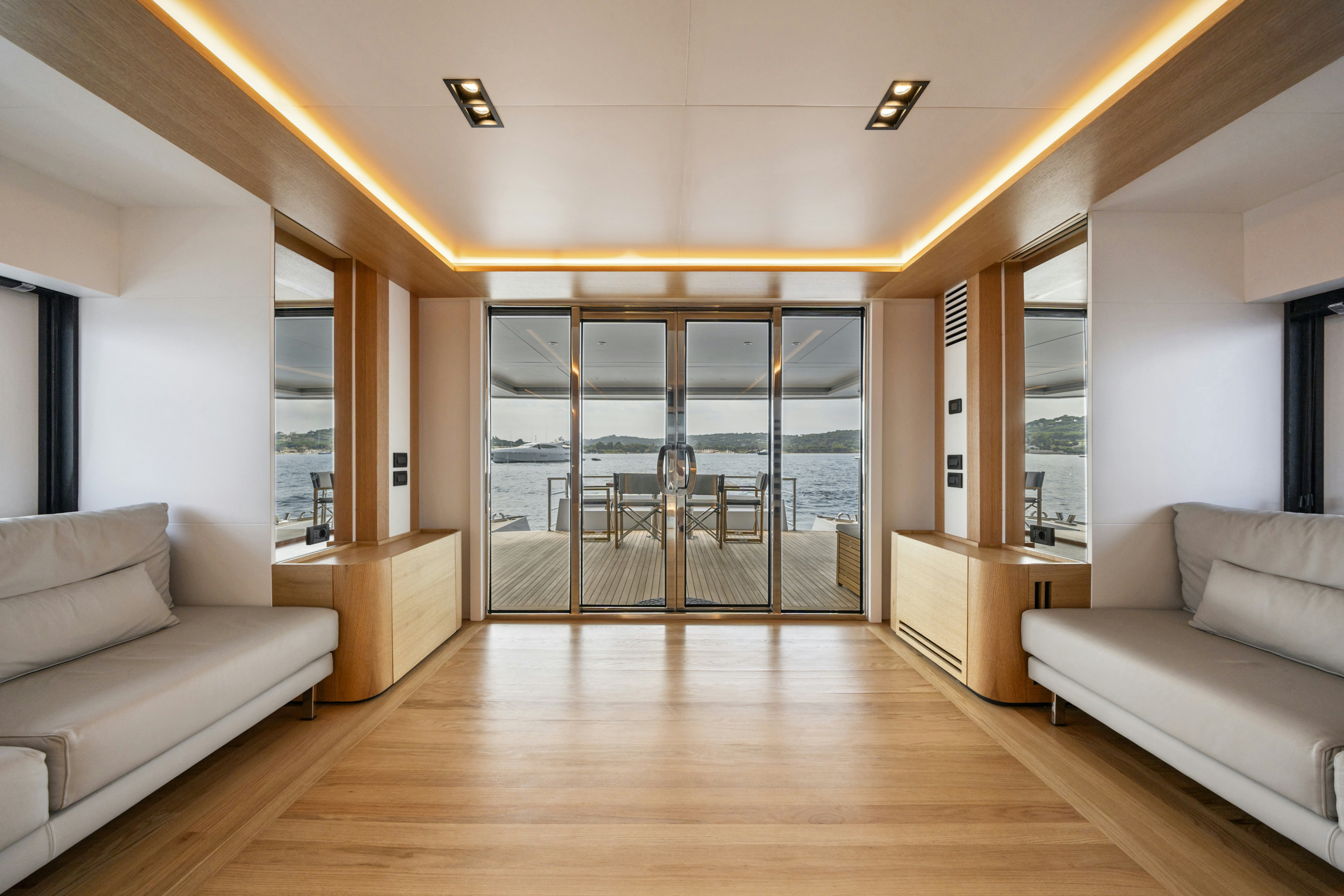 a living room with a large glass door aboard ICE Yacht for Sale