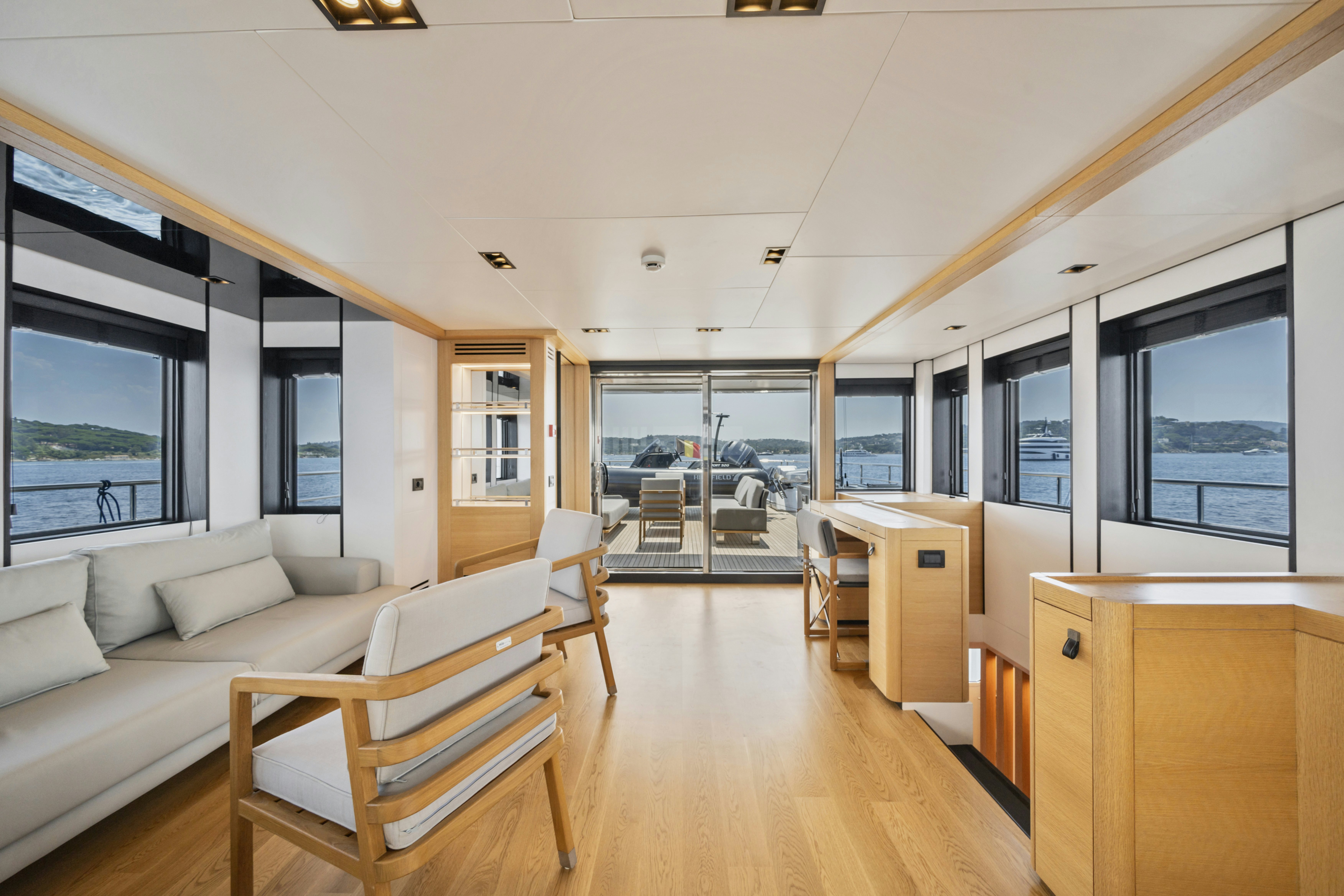 a living room with a wood floor aboard ICE Yacht for Sale