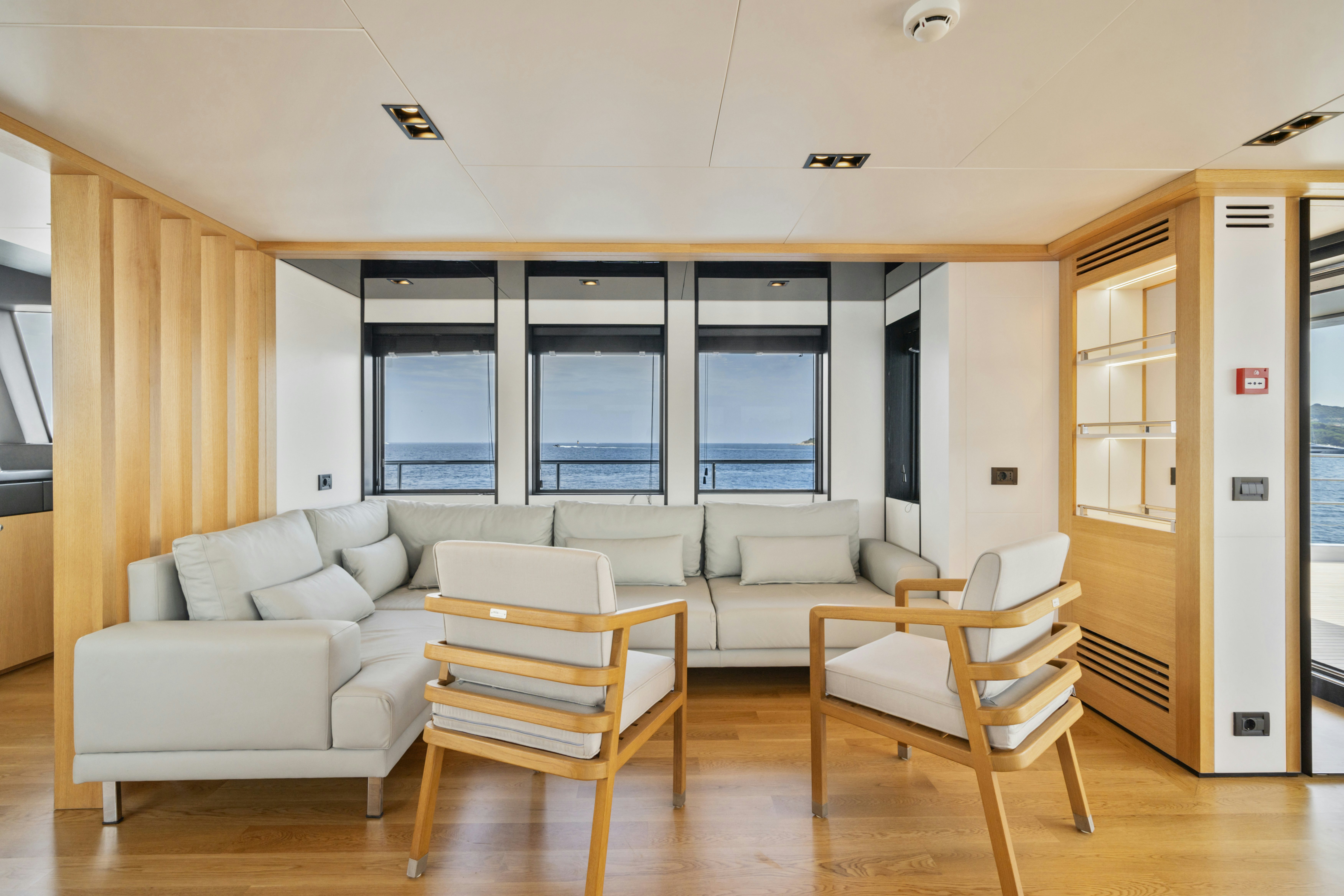 a living room with a couch and a door aboard ICE Yacht for Sale