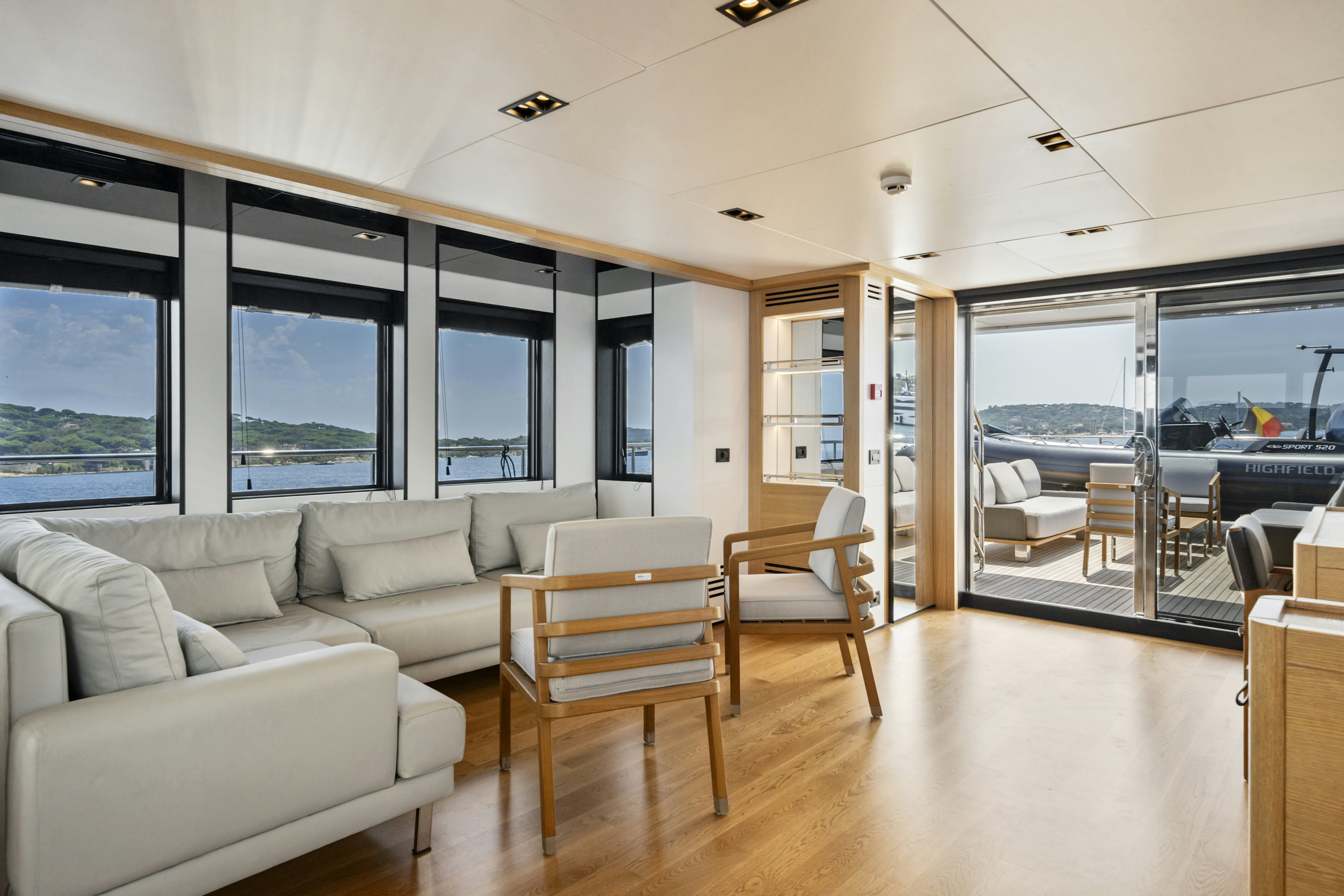 a living room with a large window aboard ICE Yacht for Sale