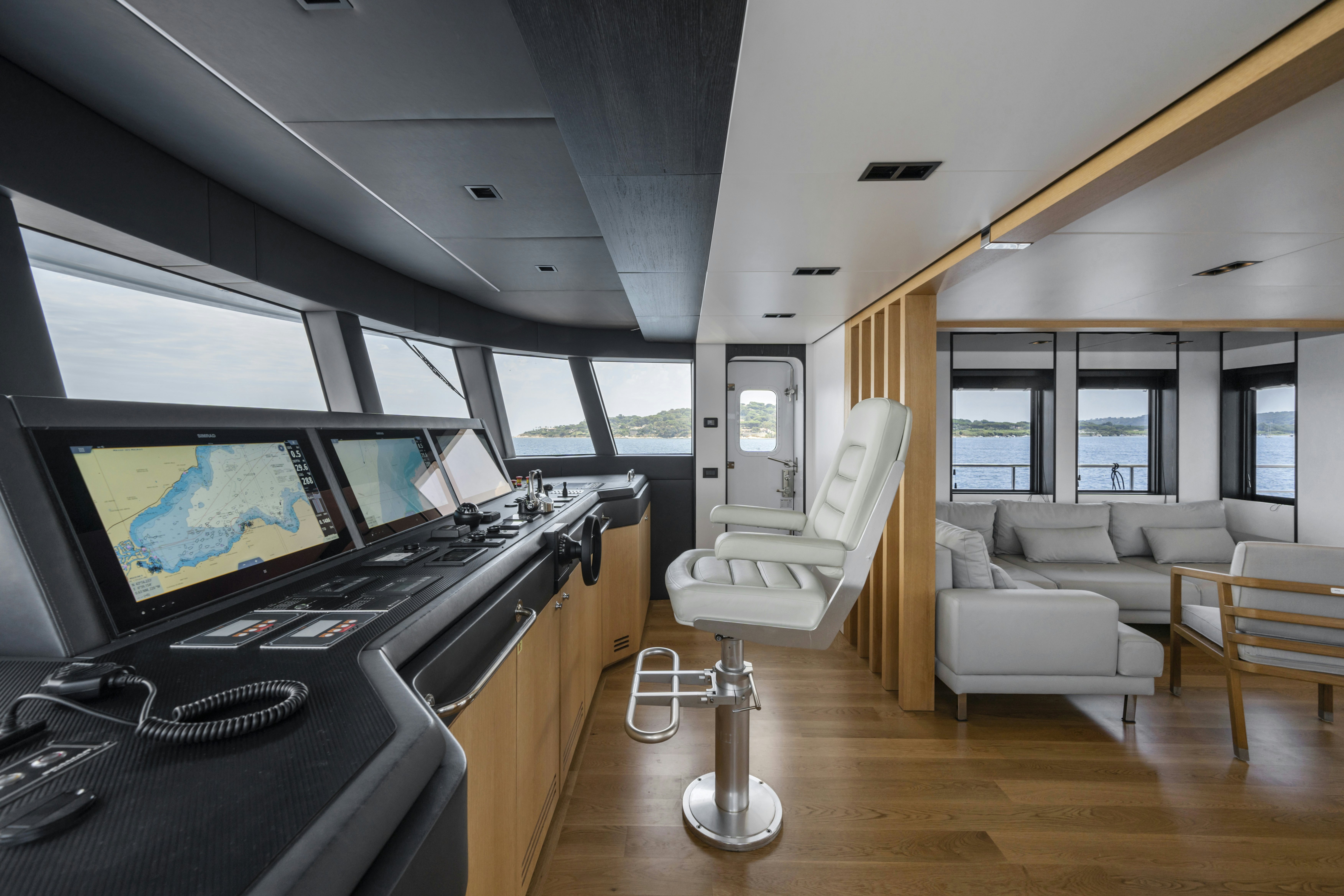 a living room with a large screen aboard ICE Yacht for Sale