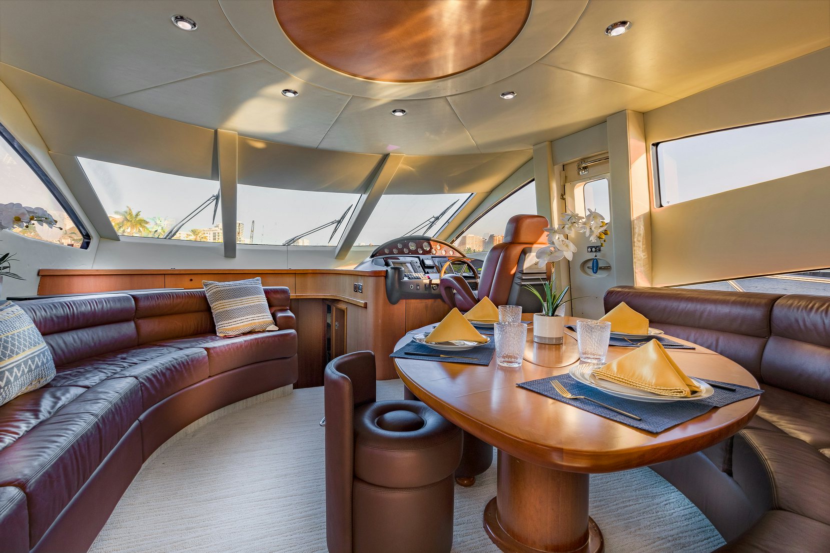 a living room with a table and couches aboard UNFORGETTABLE Yacht for Charter