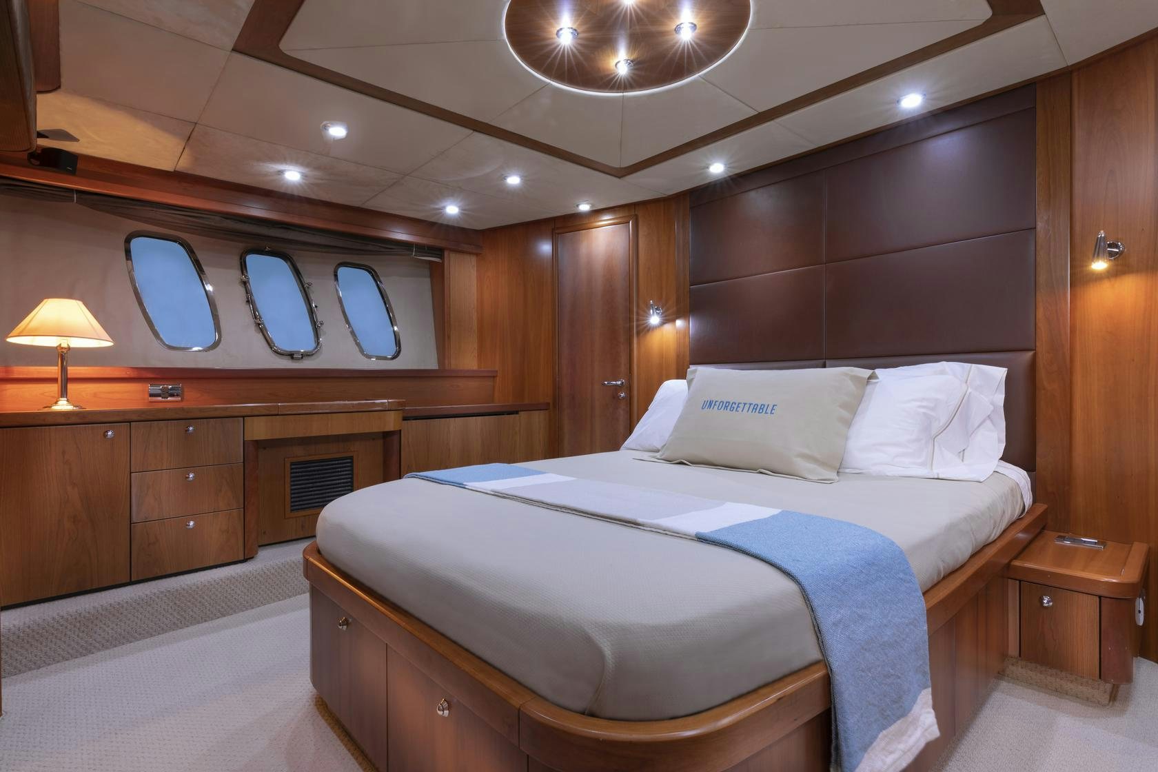 a bed with a white pillow aboard UNFORGETTABLE Yacht for Charter