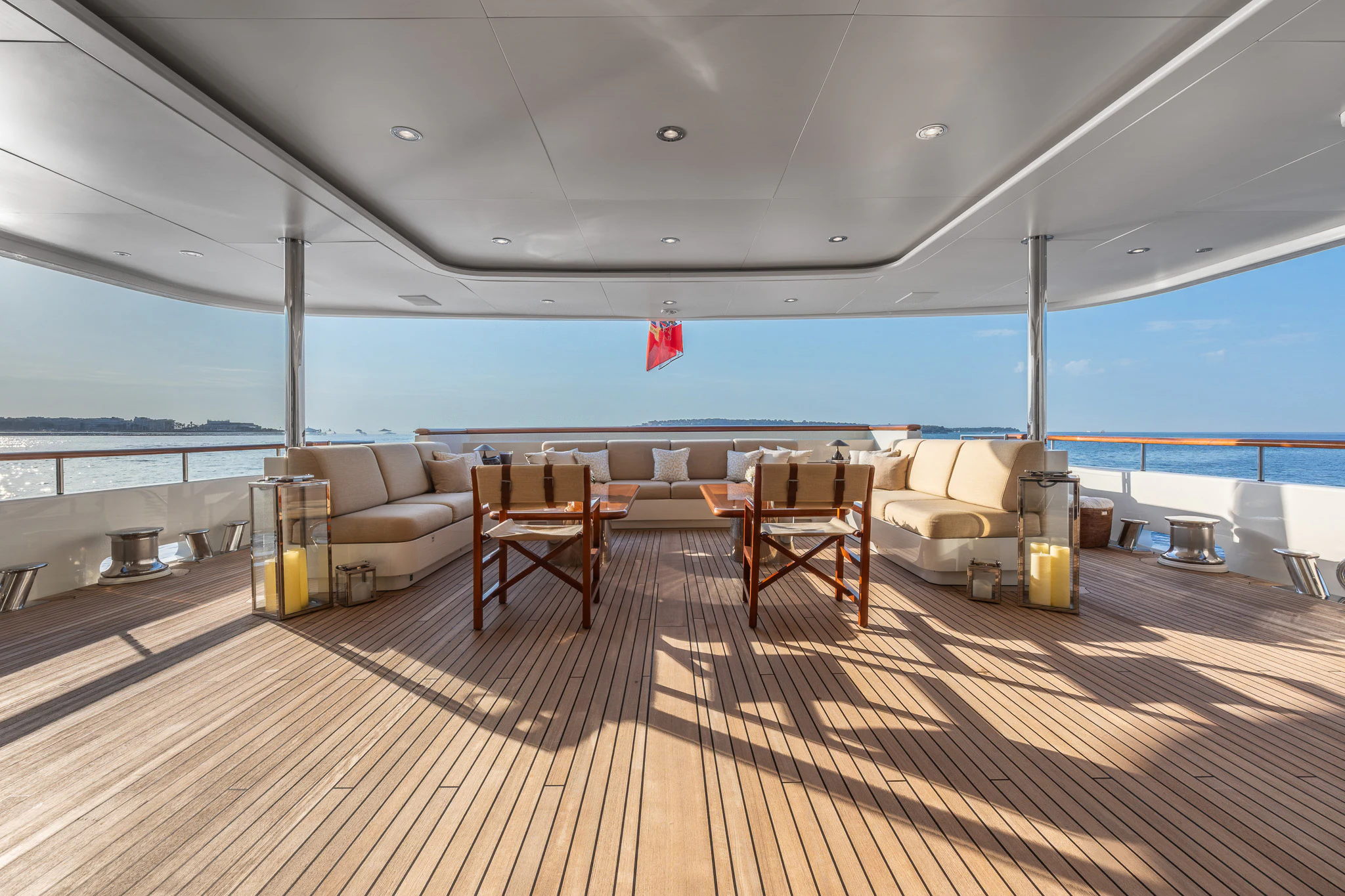 a room with a deck and chairs aboard LADY MAXINE Yacht for Sale