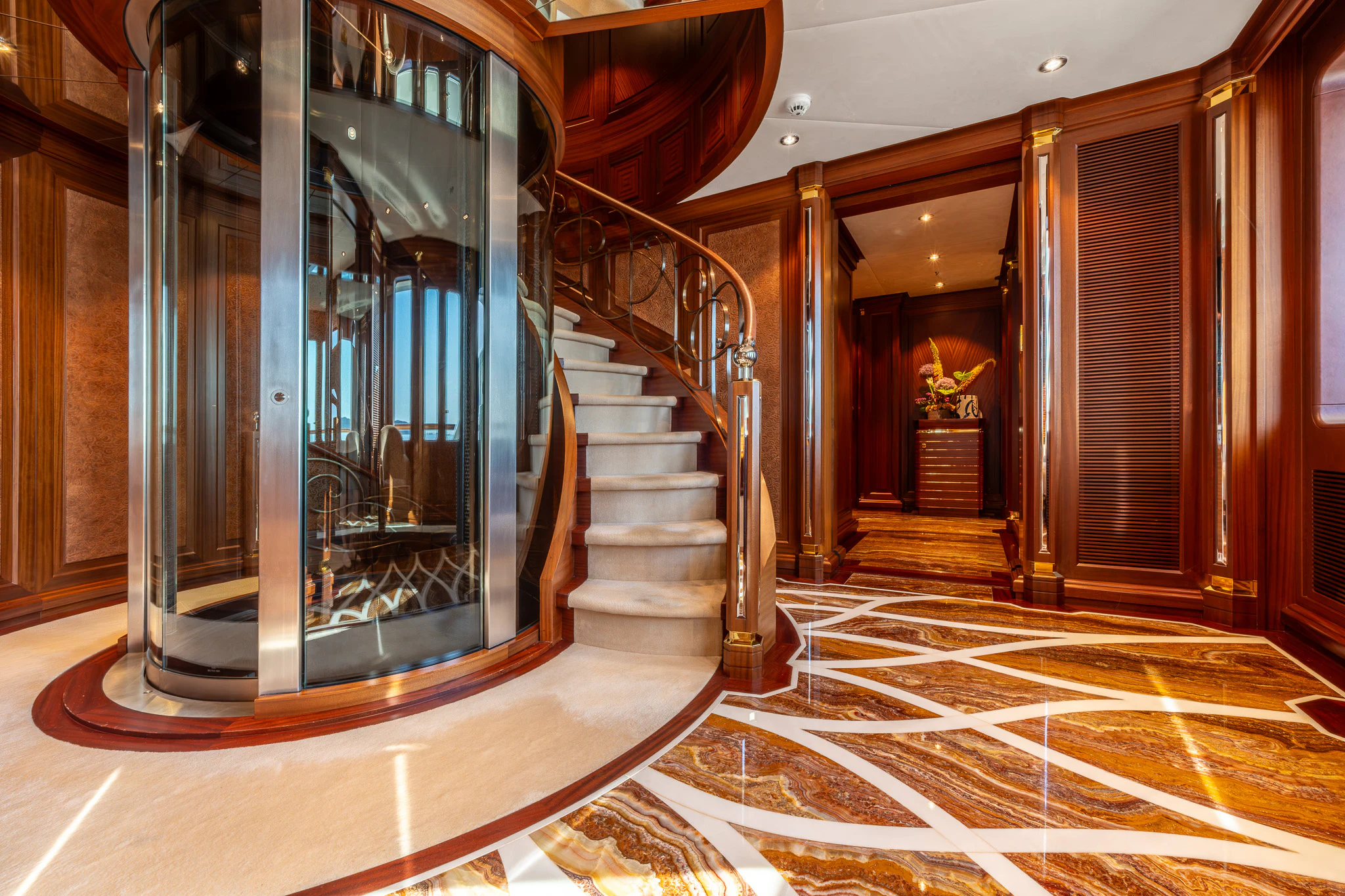 a large room with a staircase and a glass door aboard LADY MAXINE Yacht for Sale