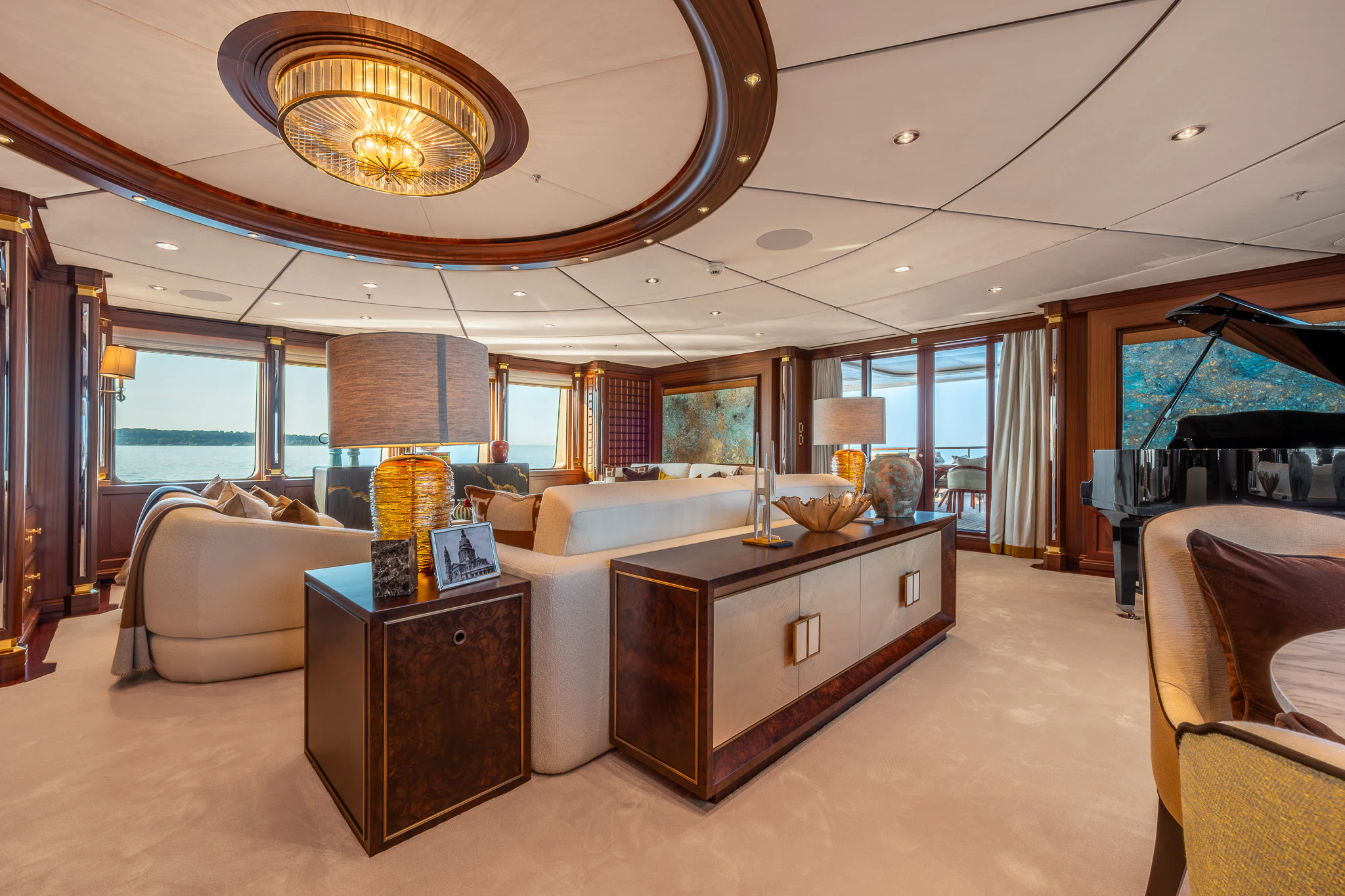 a large living room with a large chandelier aboard LADY MAXINE Yacht for Sale