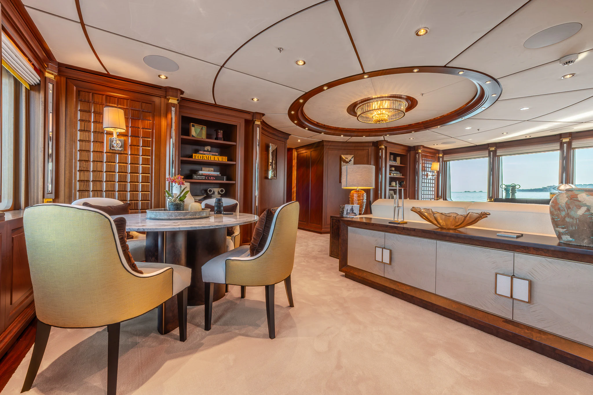 a kitchen with a bar and a table and chairs aboard LADY MAXINE Yacht for Sale
