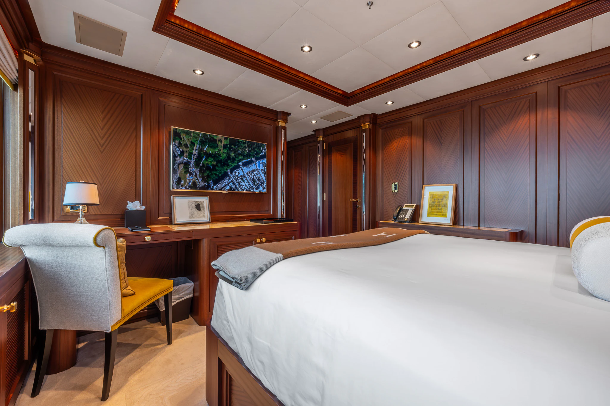 a bedroom with a bed and desk aboard LADY MAXINE Yacht for Sale