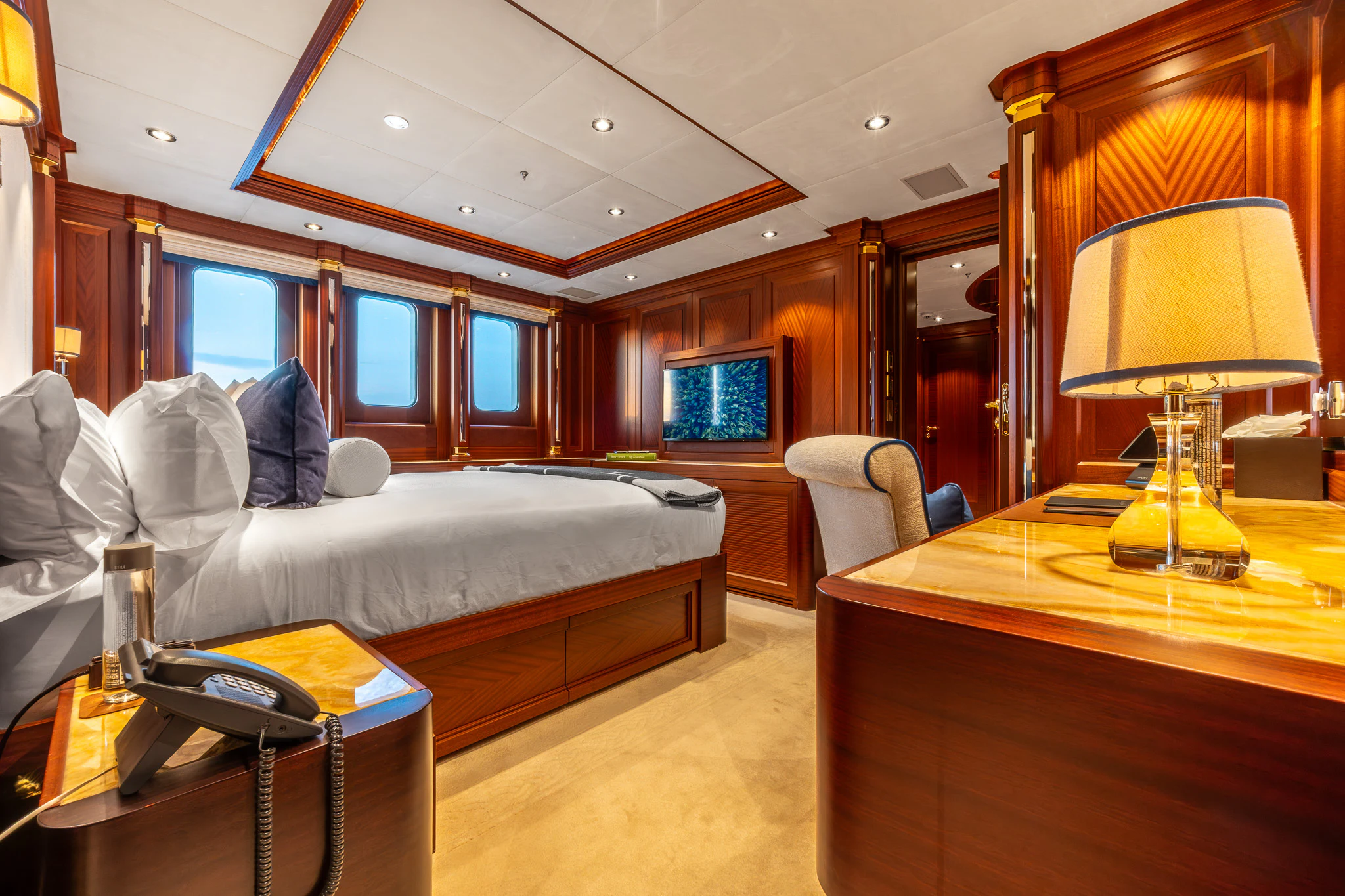 a bedroom with a bed and a desk aboard LADY MAXINE Yacht for Sale