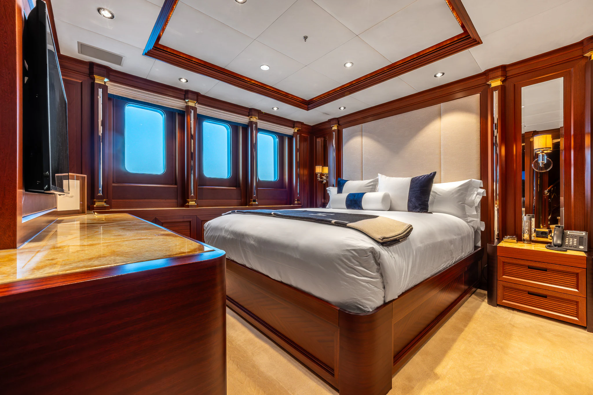 a bedroom with a bed and a desk aboard LADY MAXINE Yacht for Sale