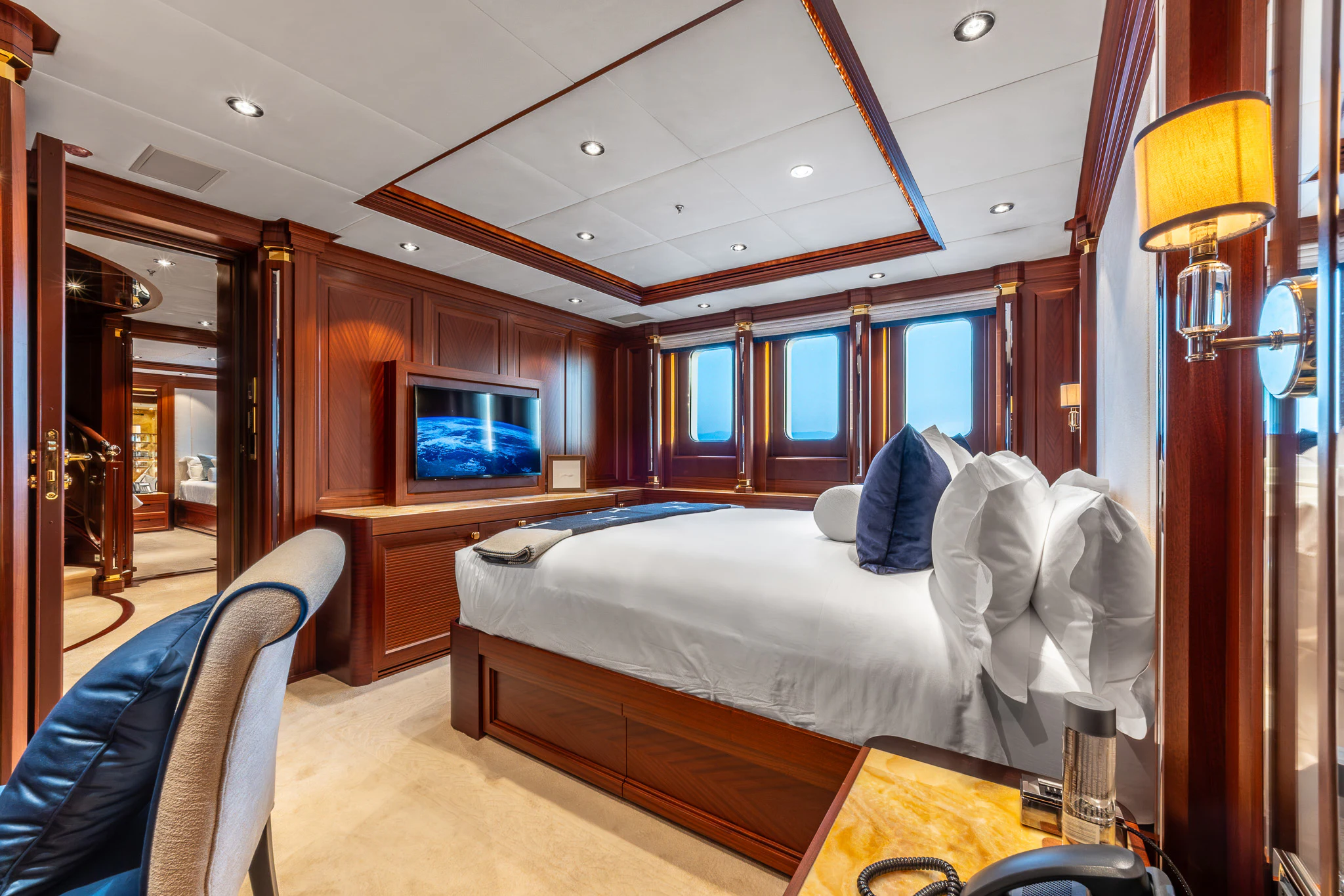 a bedroom with a bed and a desk aboard LADY MAXINE Yacht for Sale