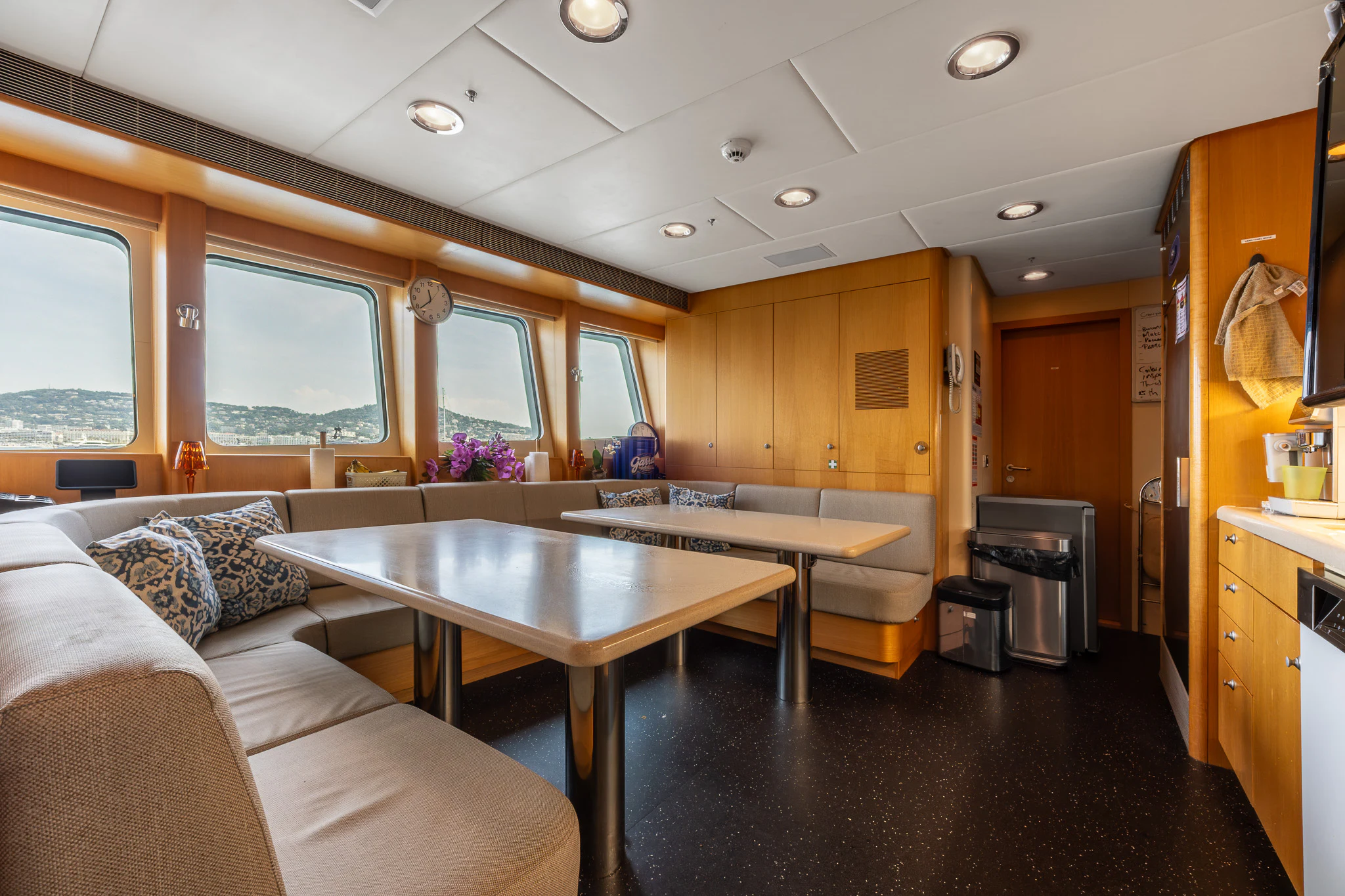 a living room with a kitchen and dining area aboard LADY MAXINE Yacht for Sale