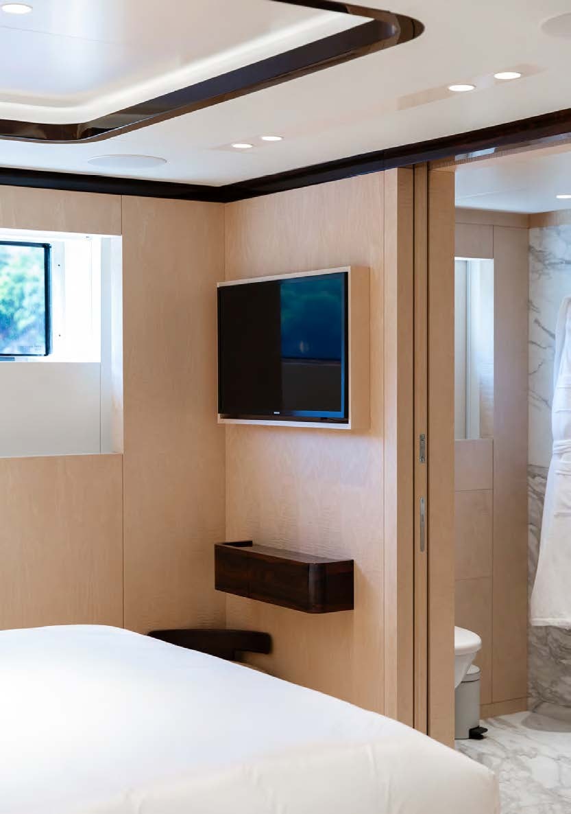 a room with a tv and a bed aboard ALUNYA Yacht for Charter