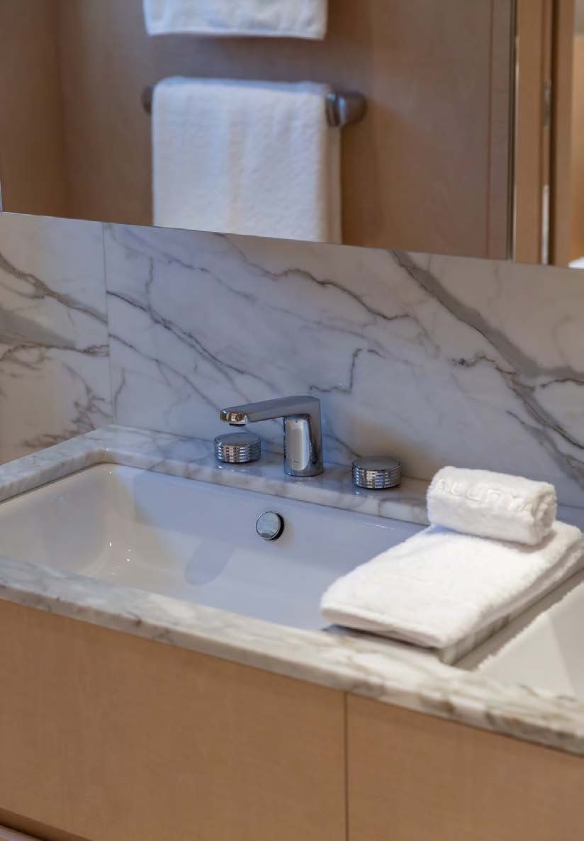 a bathroom with a sink and towels aboard ALUNYA Yacht for Charter