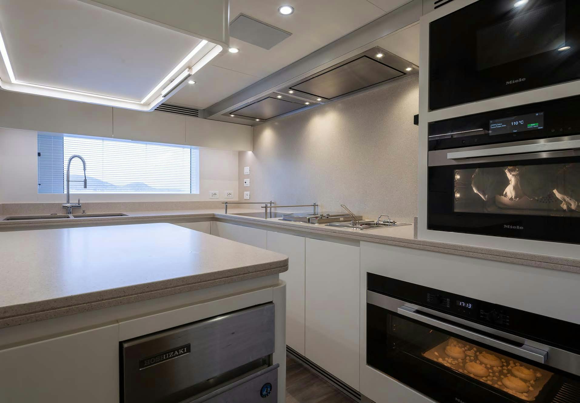 a kitchen with a stove and a microwave aboard ALUNYA Yacht for Charter