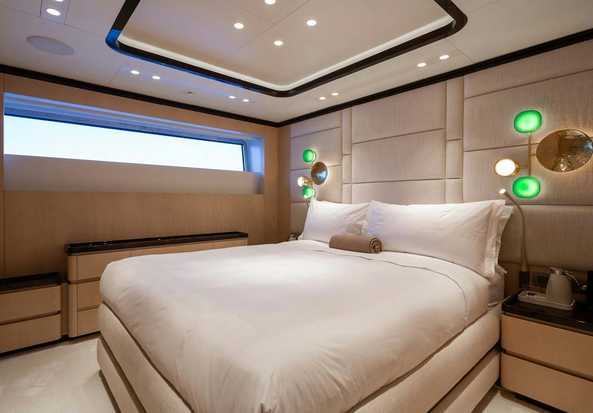 a room with a bed and a desk aboard ALUNYA Yacht for Charter
